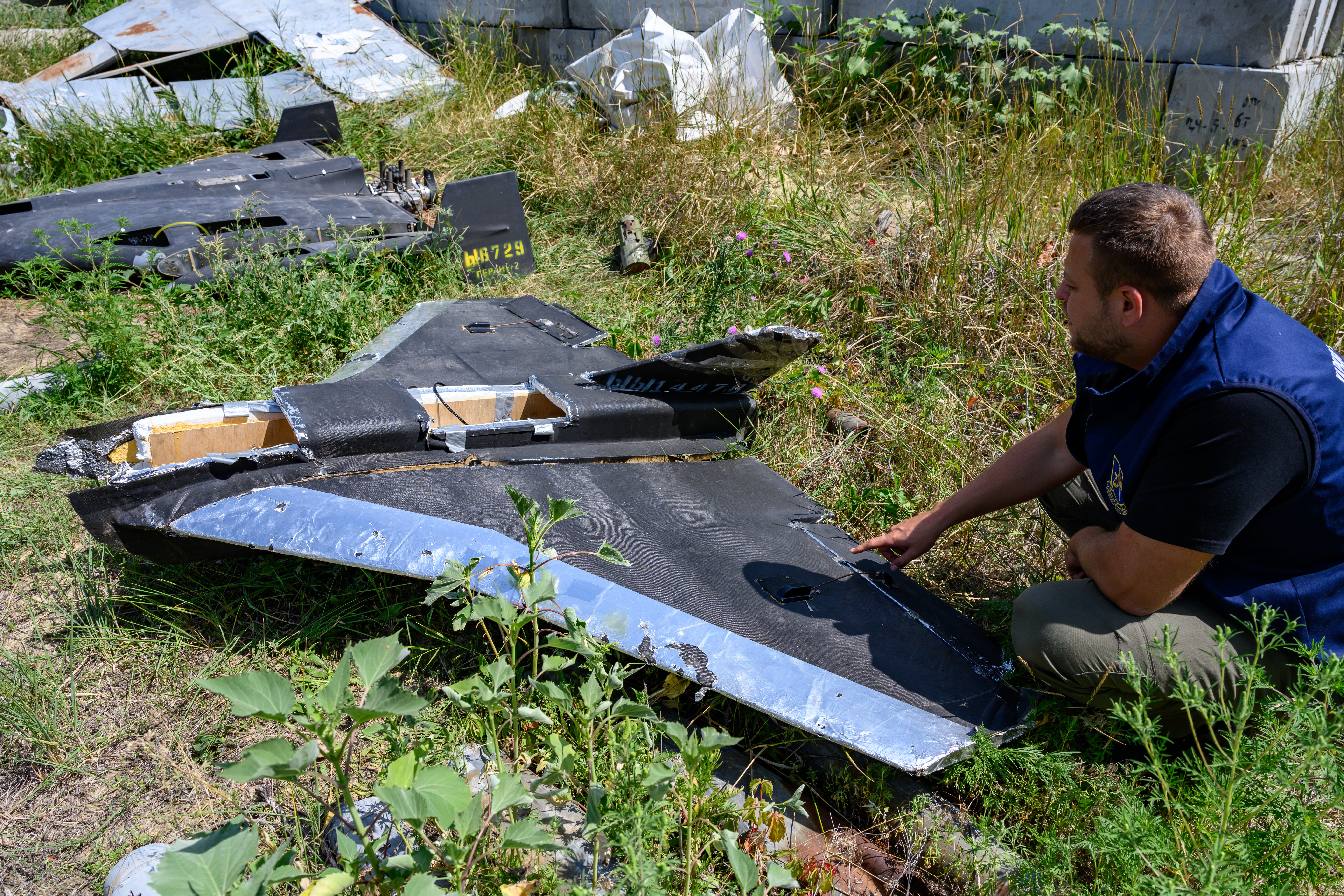 A Ukrainian official inspects the remains of a Gerbera in July 2025.