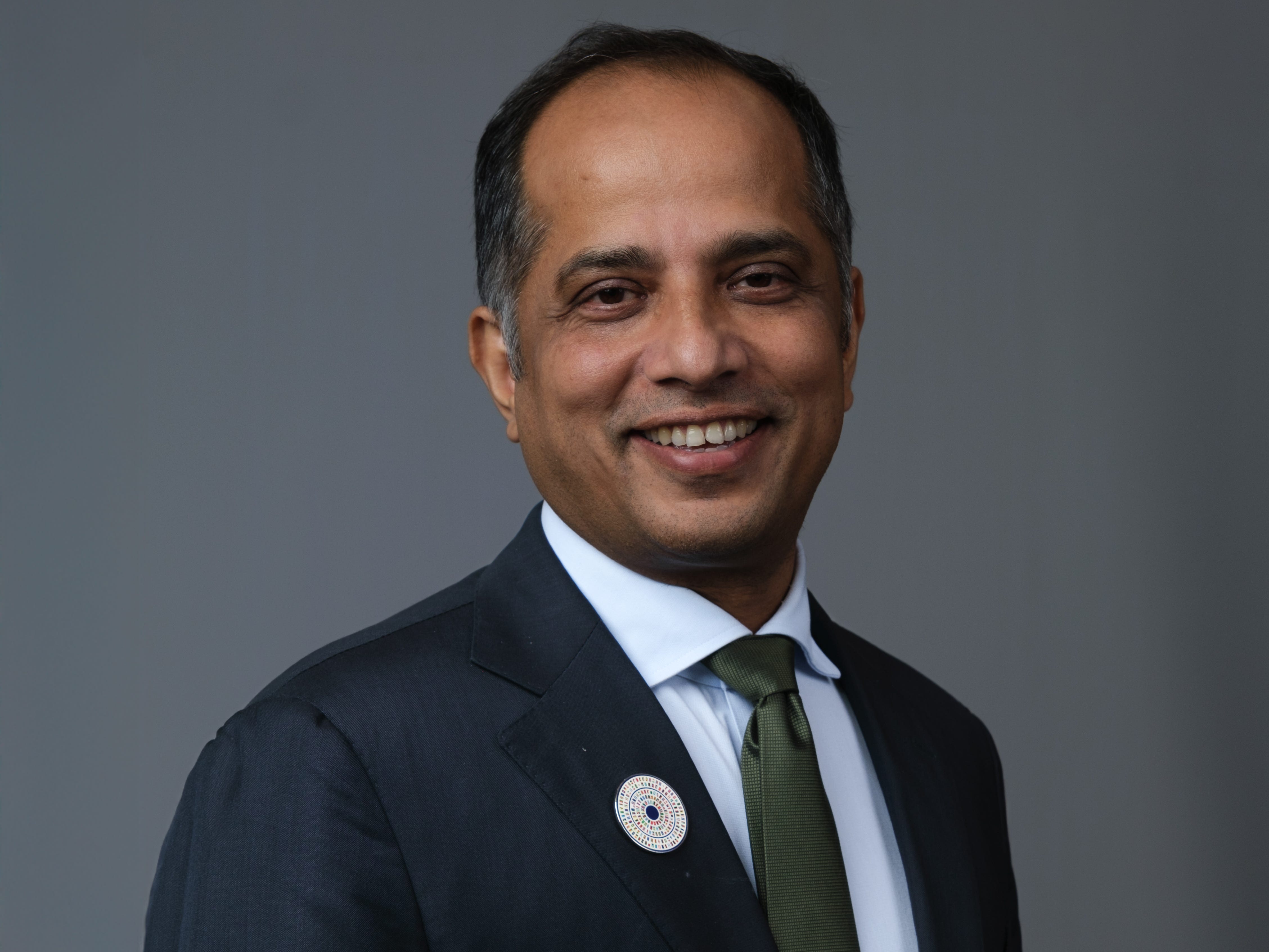 Sopnendu Mohanty, the cofounder and group CEO of the Global Finance & Technology Network, is wearing a suit and smiling.