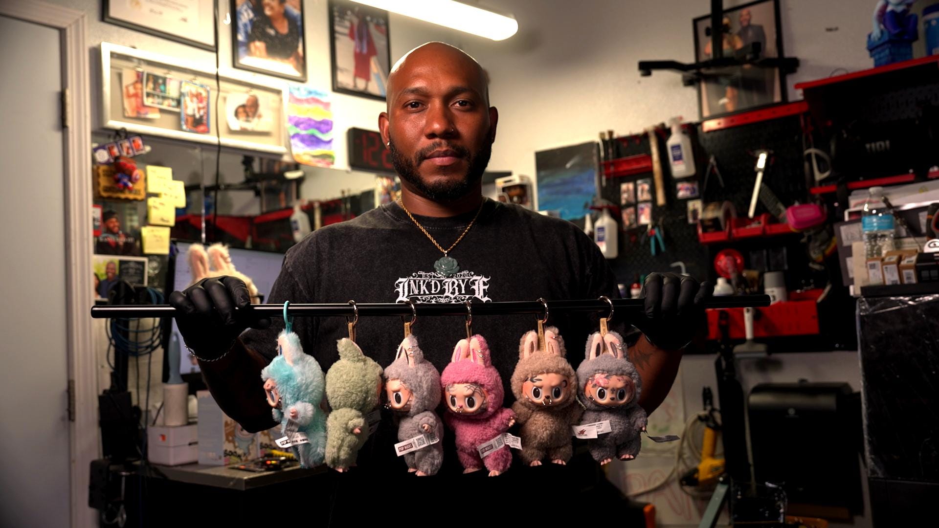 man holding six customized labubus