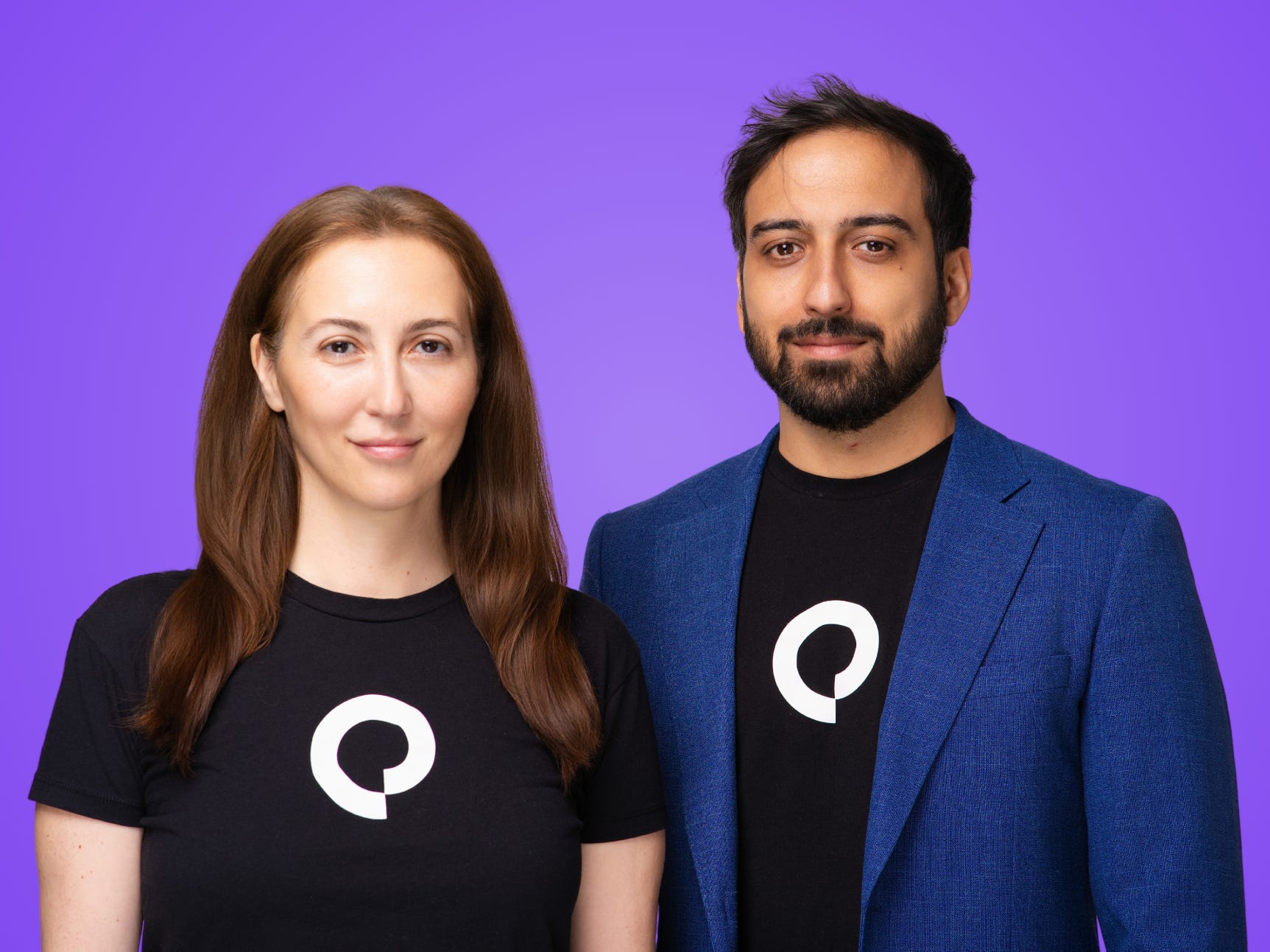 Eloquent AI Cofounders Tugce Bulut and Aldo Lipani, wearing black shirts with the company logo in front of a purple background.