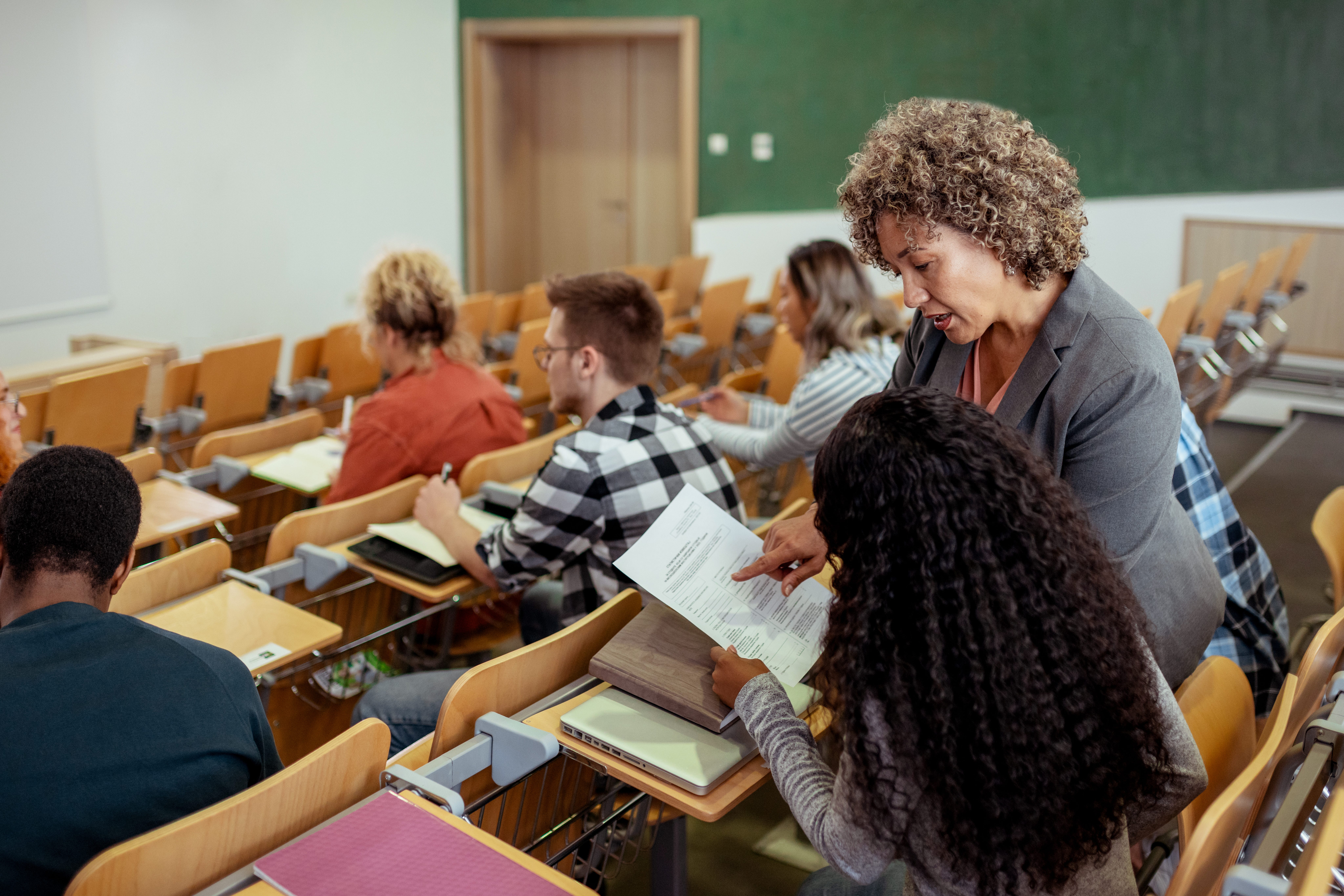 a college professor showing a college student a grade on a paper