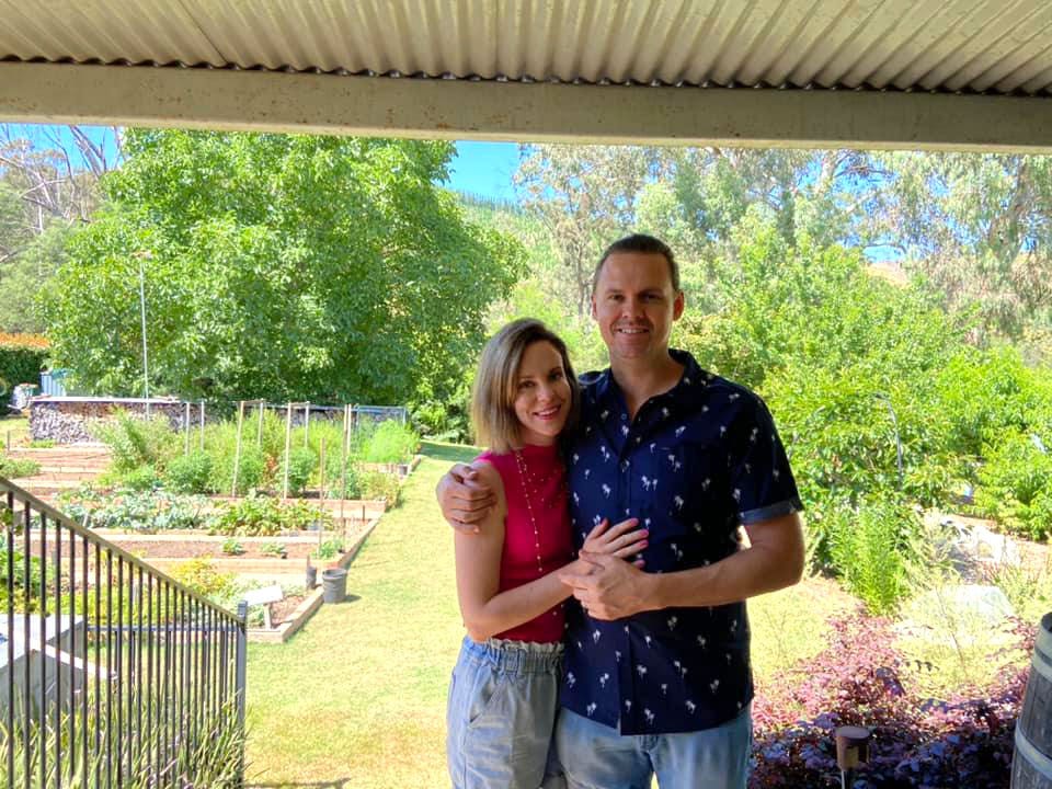 Melissa and her partner pose in her in-laws' backyard.