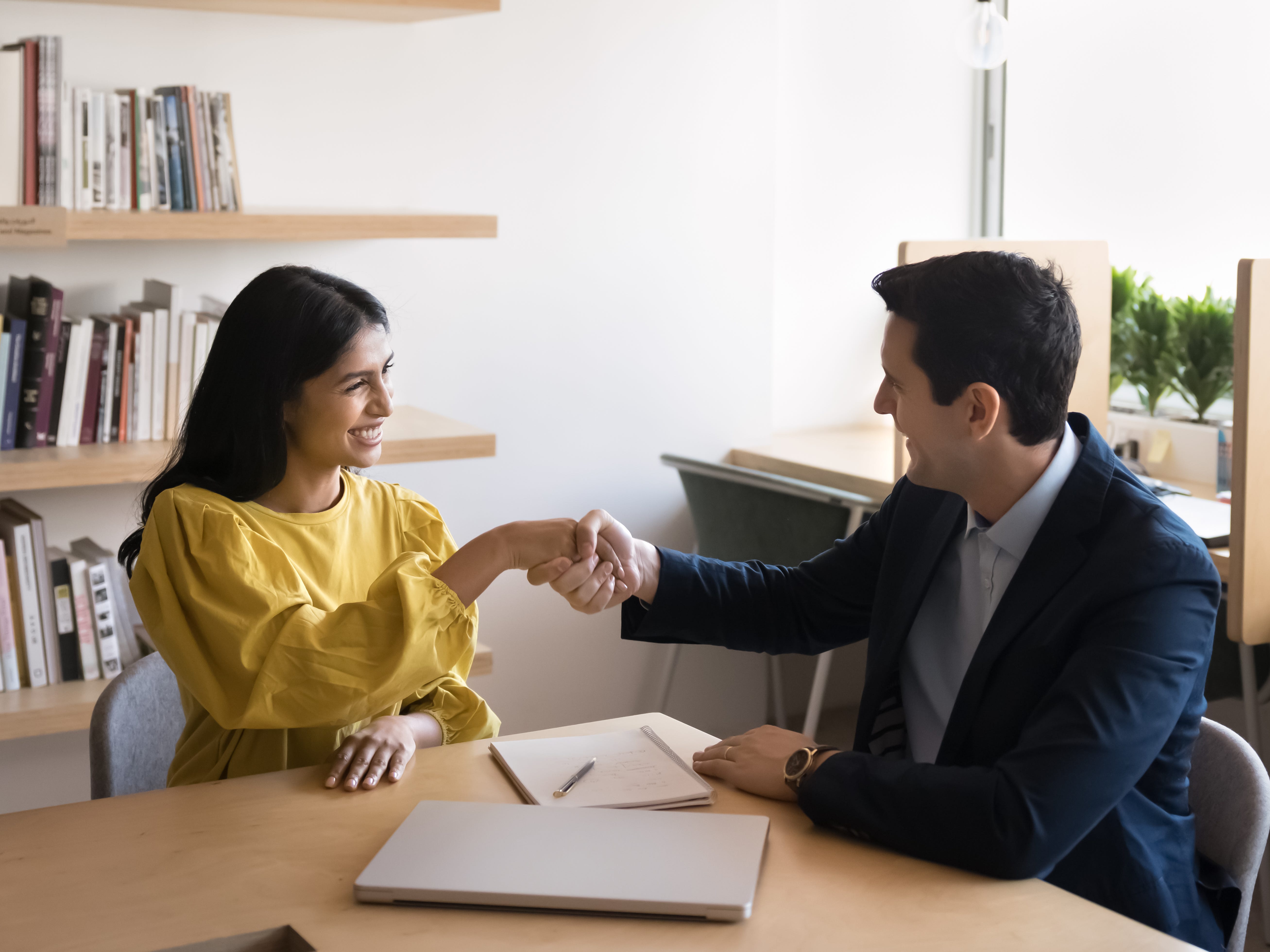 two employees shaking hands