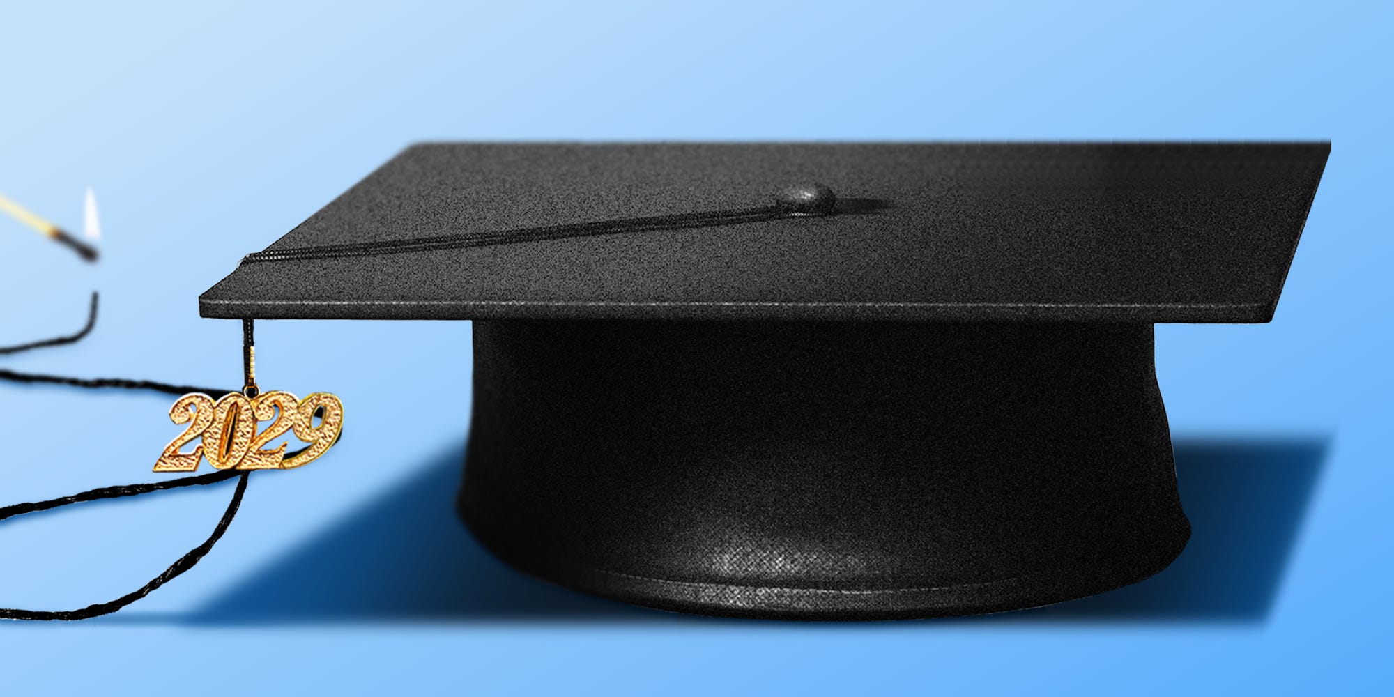 A graduation cap from the class of 2029 with a tassel acting as a long wick