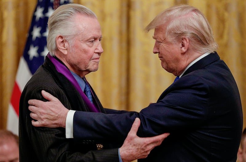 greets National Medal of Arts recipient, actor Jon Voight, during a ceremony to award the National Medal of Arts and National Humanities Medals in the East Room of the White House in Washington, U.S., November 21, 2019. REUTERS/Tom Brenner