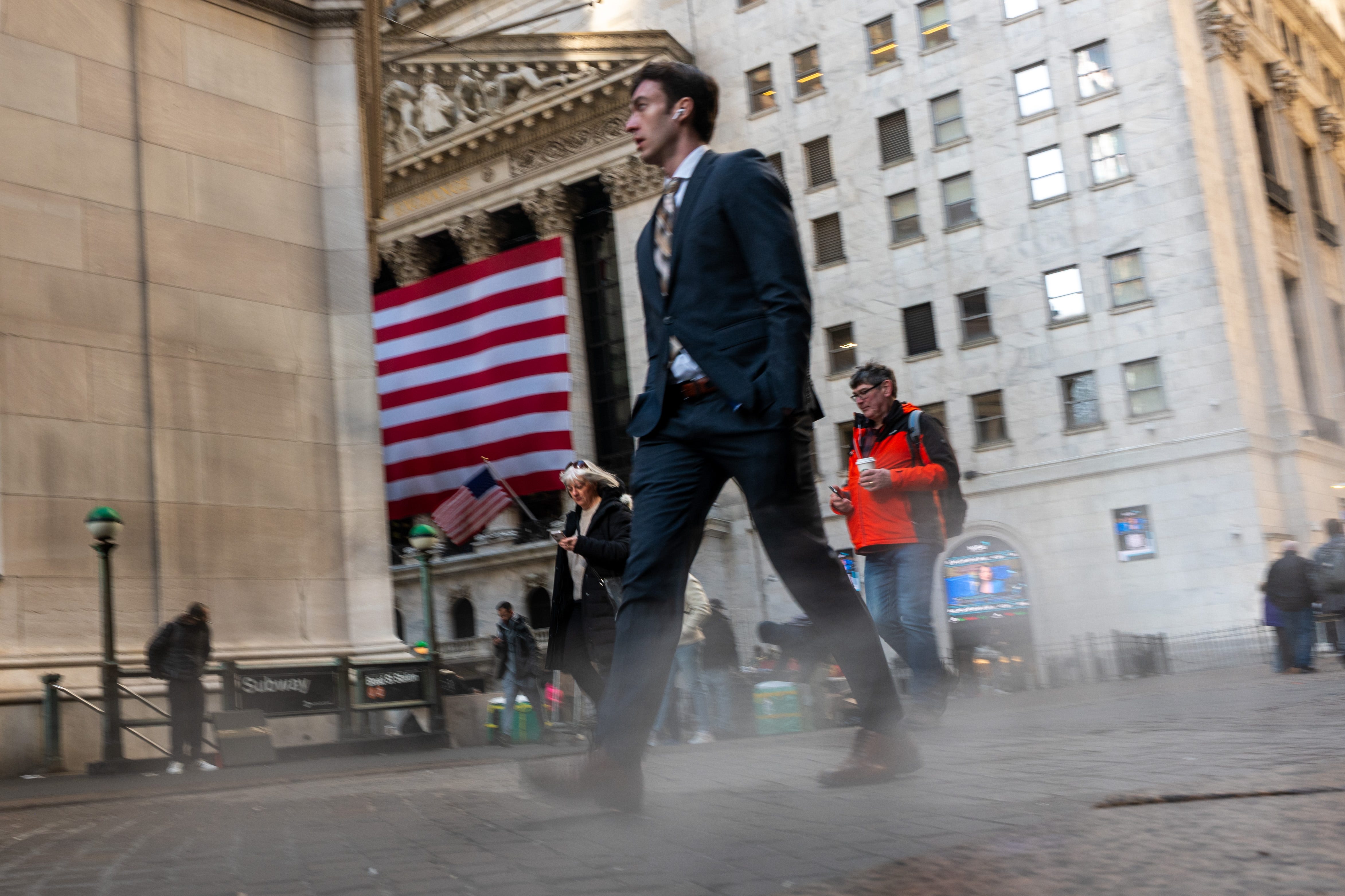 A man walks by the NYSE