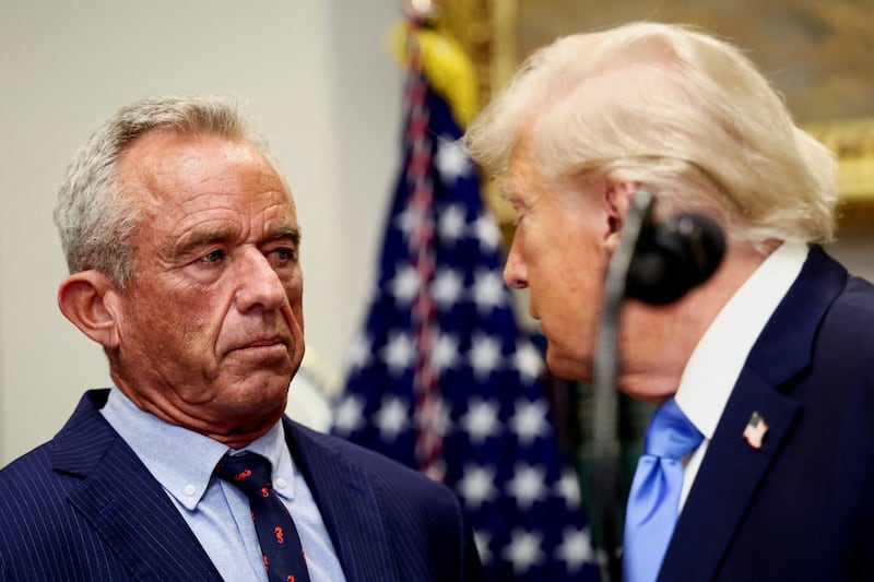 U.S. President Donald Trump turns to look at U.S. Secretary of Health and Human Services Robert F. Kennedy Jr., while making an announcement linking autism to childhood vaccines and to the use of popular pain medication Tylenol for pregnant women and children, claims which are not backed by decades of science, at the White House, in Washington, D.C., U.S., September 22, 2025. REUTERS/Kevin Lamarque