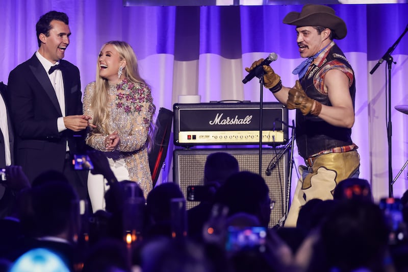 Charlie Kirk (L) and and his wife Erika Lane Frantzve (C) watch as The Village People perform on stage during the Turning Point USA Inaugural-Eve Ball at the Salamander Hotel on January 19, 2025 in Washington, DC.