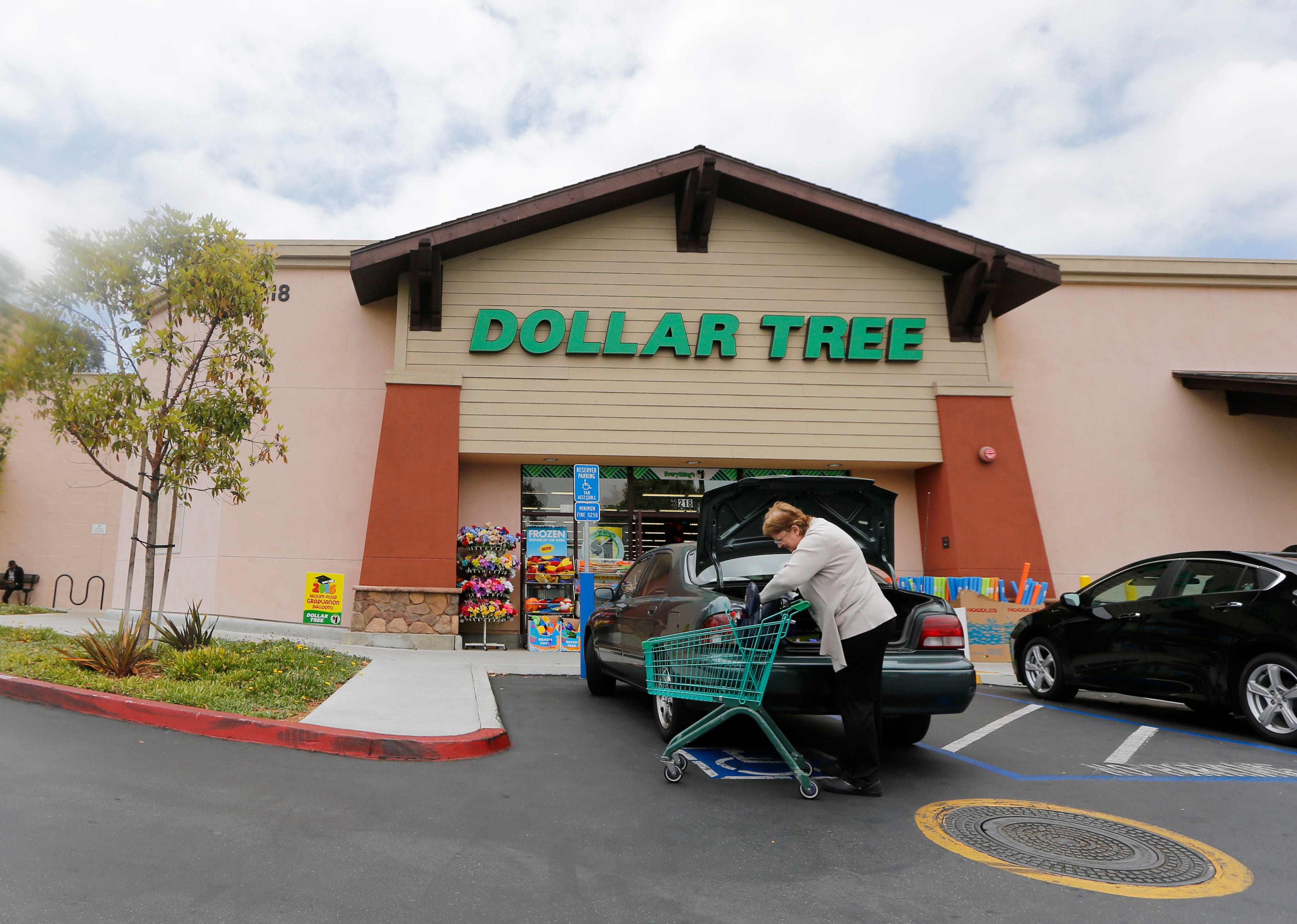 FILE - In this May 26, 2016, file photo, a shopper searches her purse outside a Dollar Tree store in Encinitas, Calif. Dollar Tree Inc. on Tuesday, Nov. 26, 2019, reported fiscal third-quarter profit of $255.8 million. (AP Photo/Lenny Ignelzi, File)