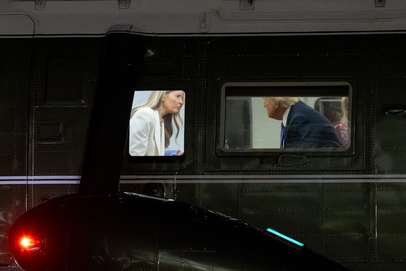 US President Donald Trump speaks with First Lady Melania Trump onboard Marine One