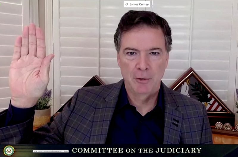 FILE PHOTO: James Comey, former director of the Federal Bureau of Investigation (FBI), is seen in a frame grab from a video feed as he is sworn in remotely from his home during a Senate Judiciary Committee hearing exploring the FBI's investigation of the 2016 Trump campaign and Russian election interference in Washington, U.S., September 30, 2020. U.S. Senate Committee on the Judiciary/Handout via REUTERS//File Photo