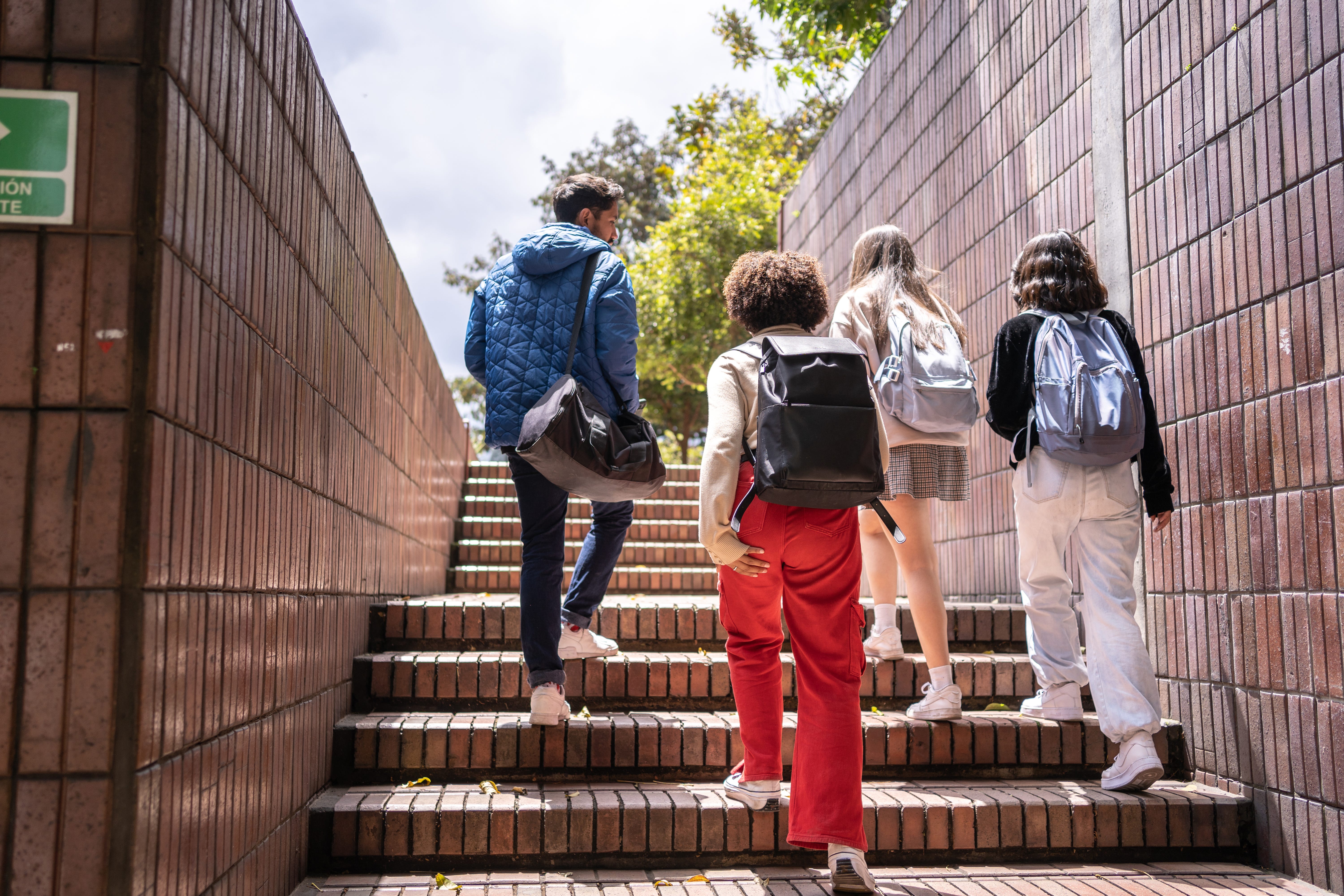 Back of young people walking