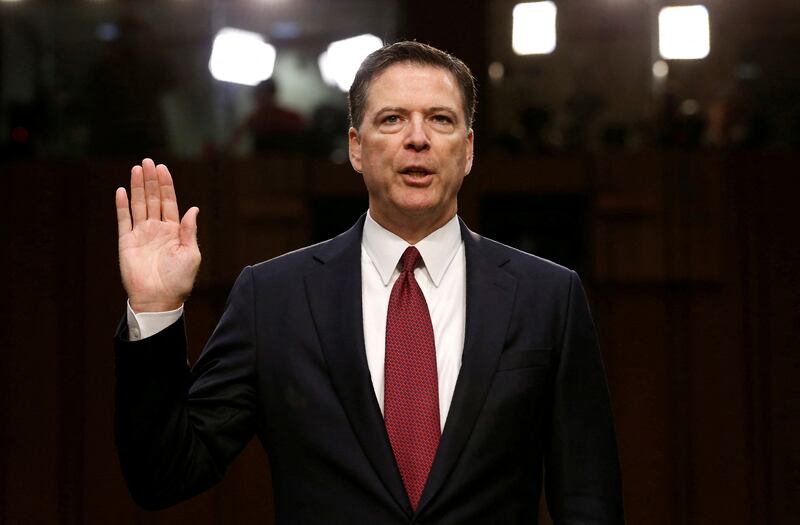 FILE PHOTO: Former FBI Director James Comey is sworn in prior to testifying before a Senate Intelligence Committee hearing on Russia's alleged interference in the 2016 U.S. presidential election on Capitol Hill in Washington, U.S., June 8, 2017. REUTERS/Jonathan Ernst//File Photo