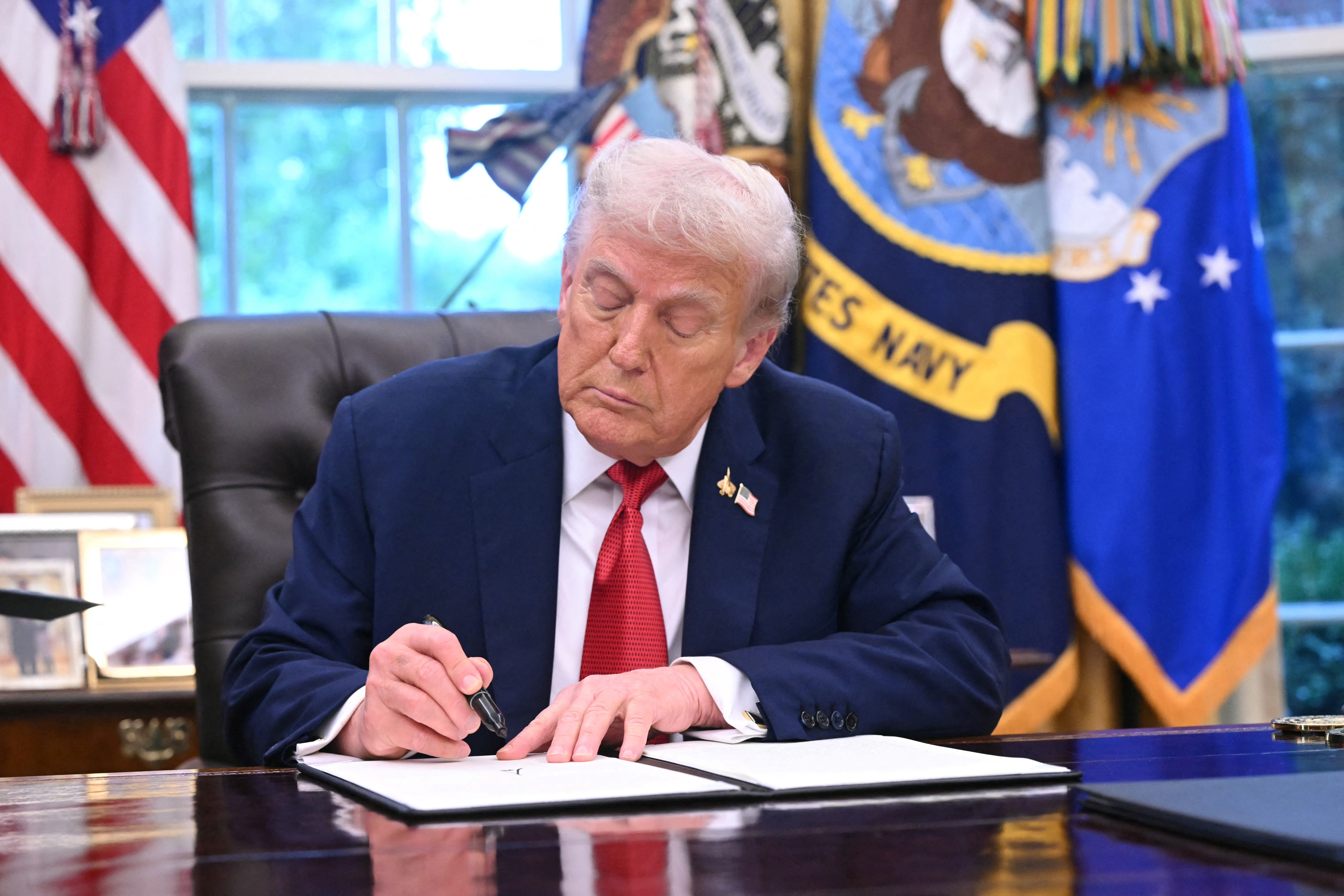 US President Donald Trump signs an executive order about Tiktok in the Oval Office of the White House in Washington, DC, on September 25, 2025.