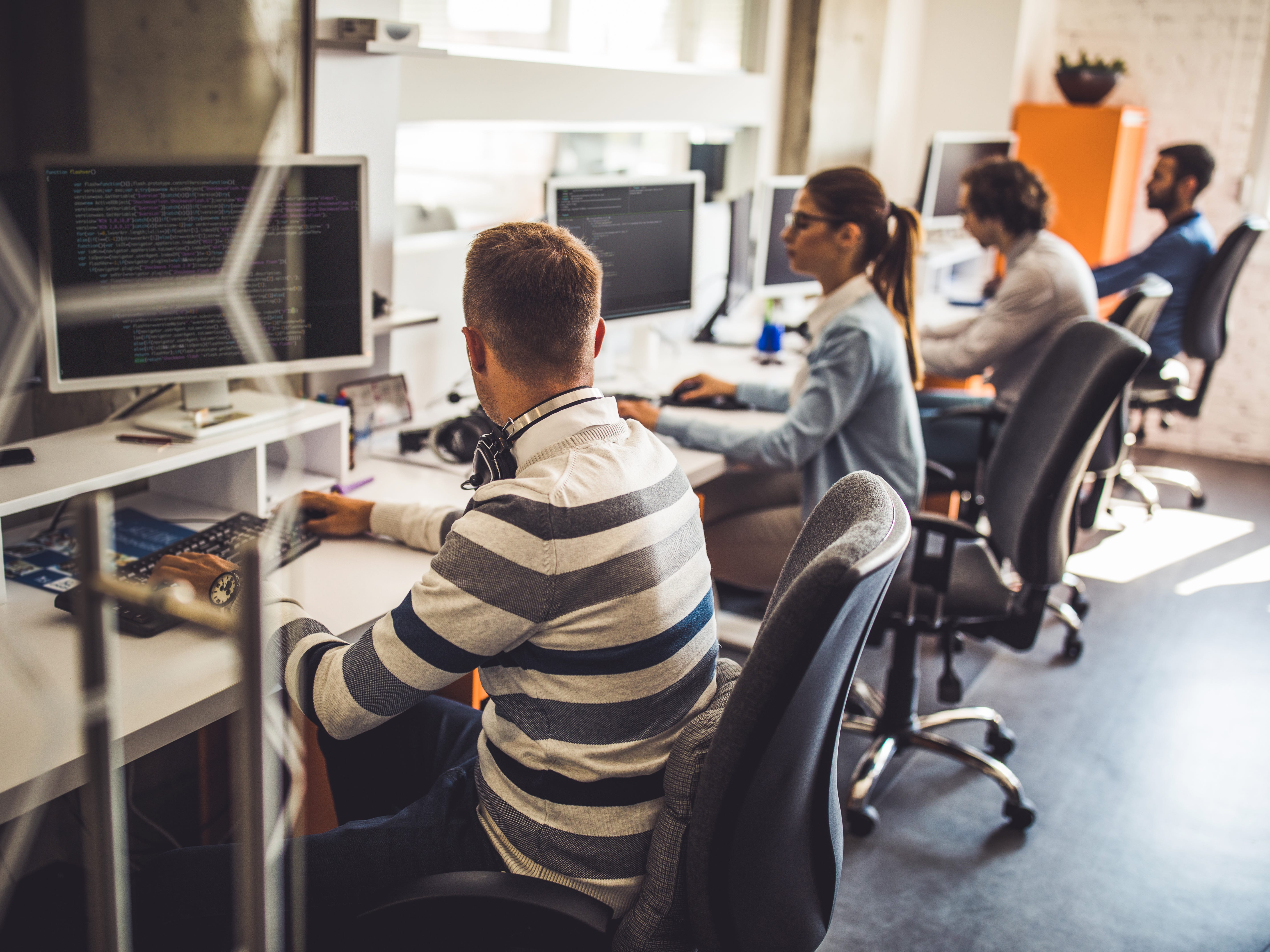 People using computers in an office