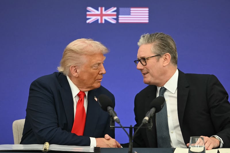 Britain's Prime Minister Keir Starmer (R) and Donald Trump (L) shake hands at a Business event at Chequers, in Aylesbury, central England, on September 18, 2025,