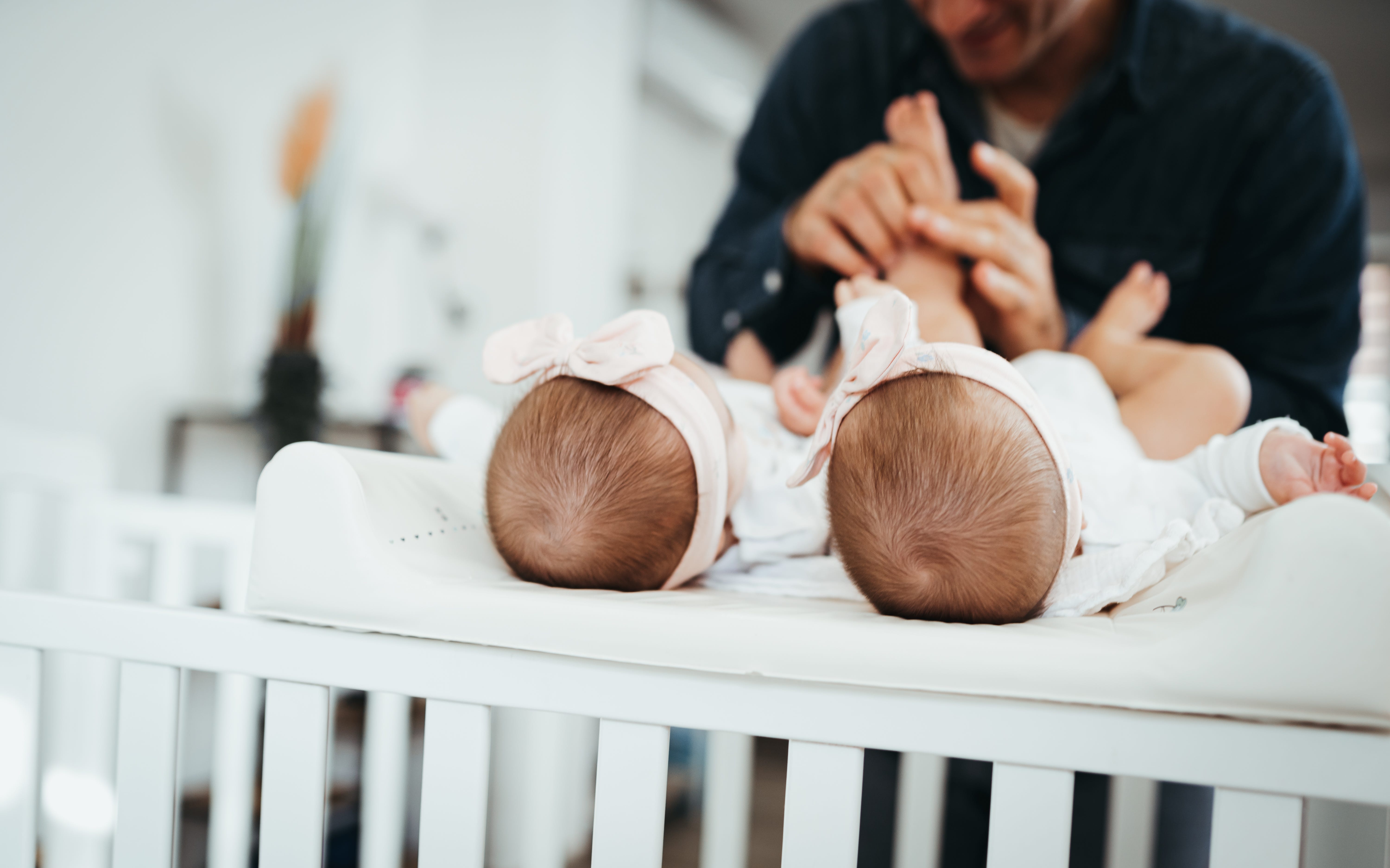 A dad with his baby twin daughters