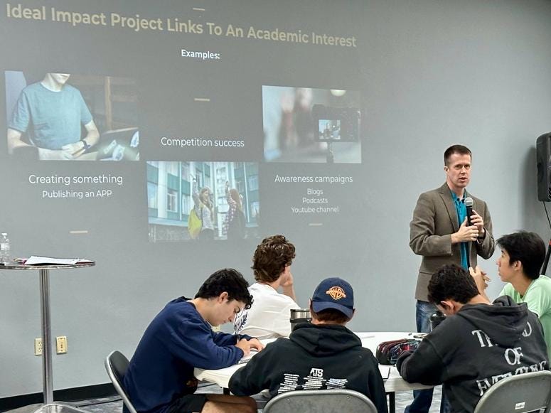 Steve Gardner at the head of the classroom teaching a class full of students