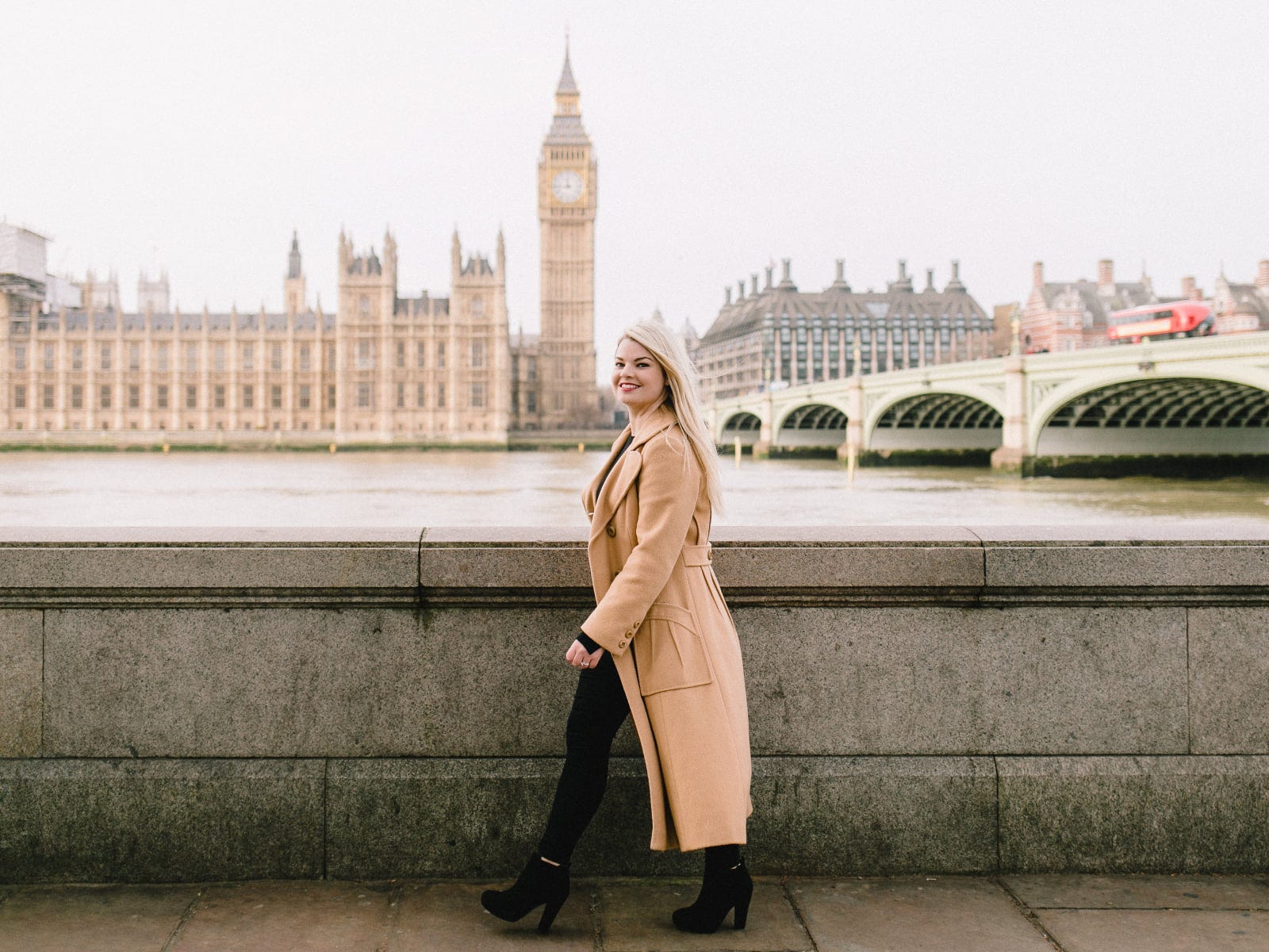 Rachel Reva in london walking in front of big ben and parliment