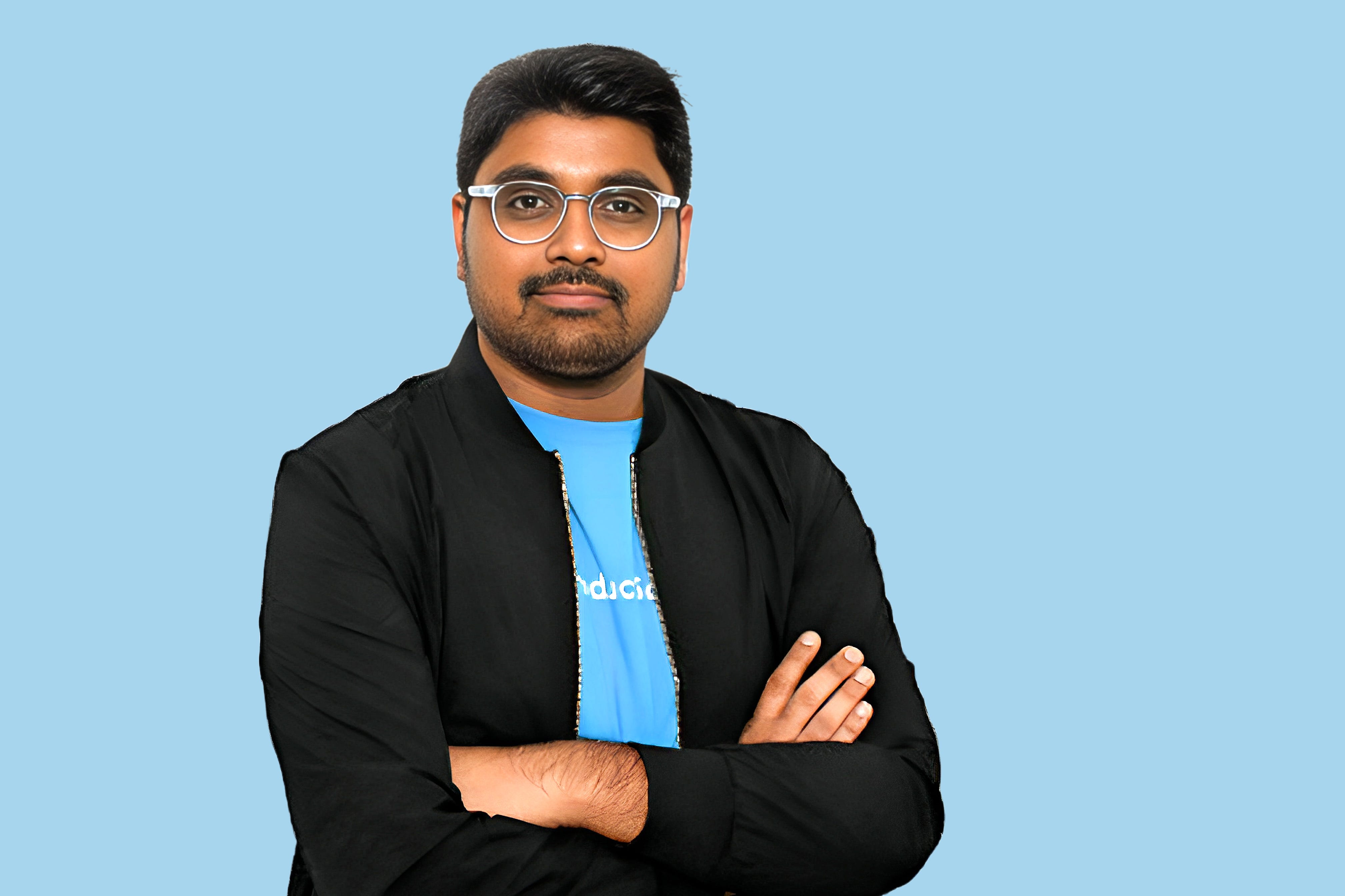 headshot of a man on a blue background