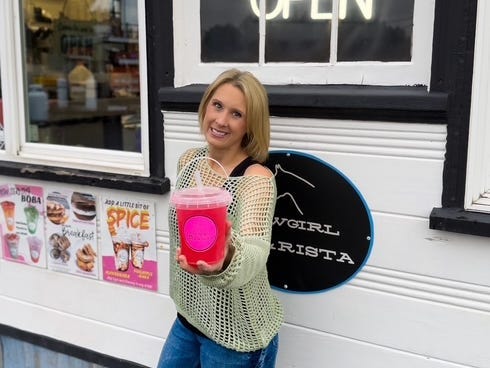 Nicole McMillian, the owner of Cowgirl Barista, poses in front of her coffee shop.