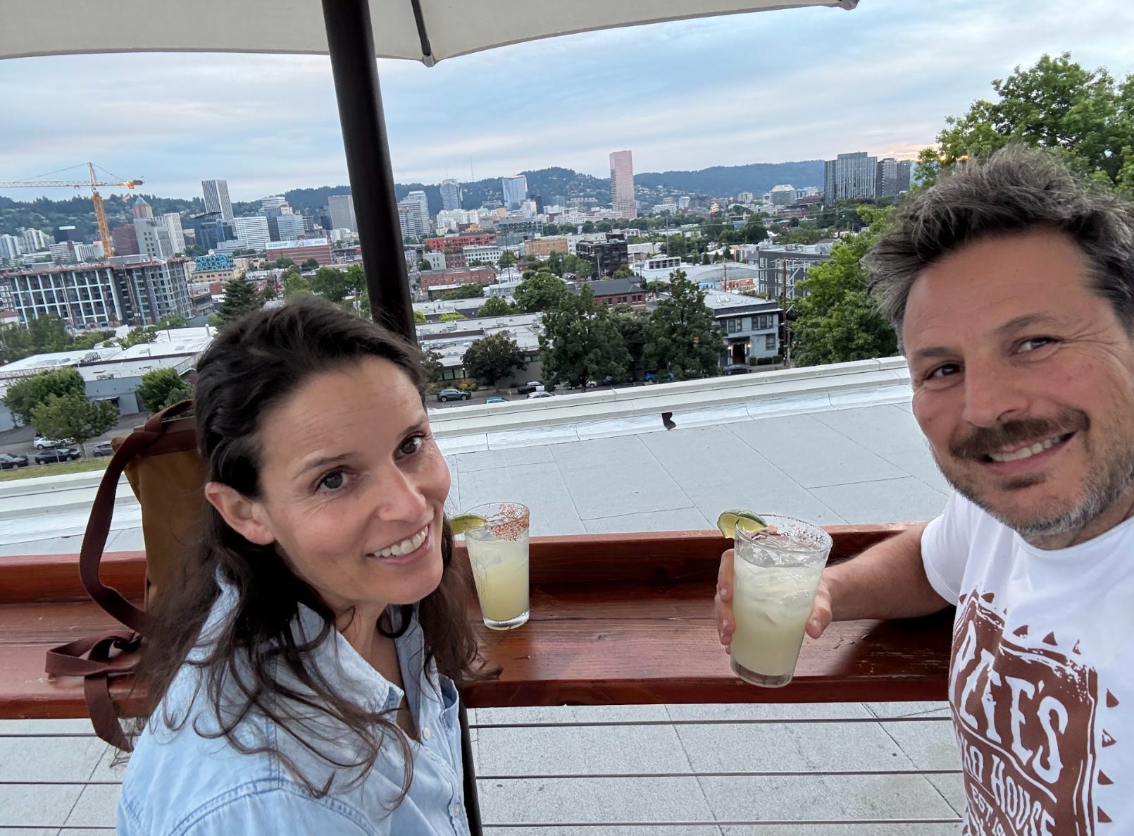 The writer and his spouse drinking on a rooftop in Portland.