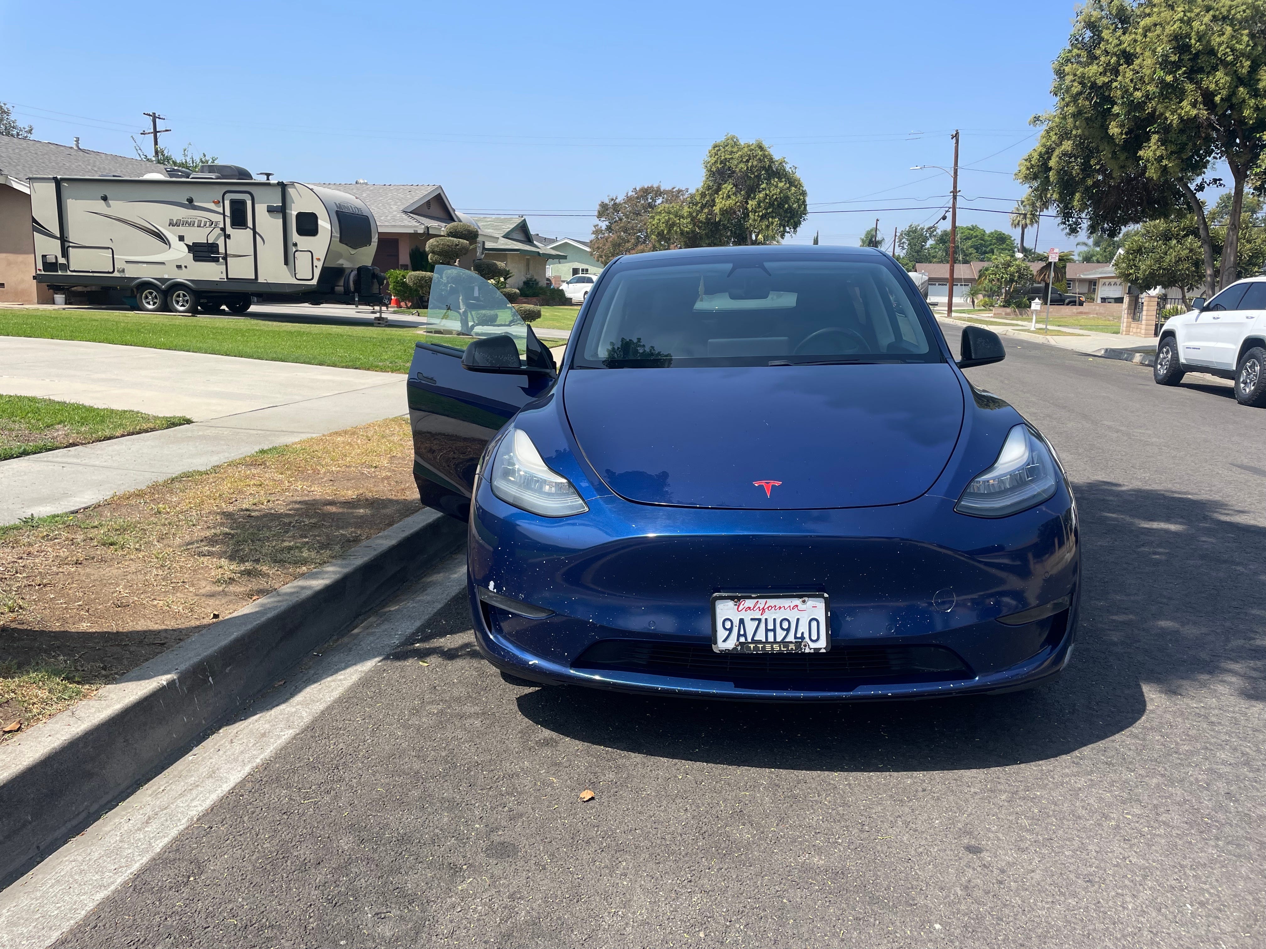The blue Tesla Model Y that the author rented.