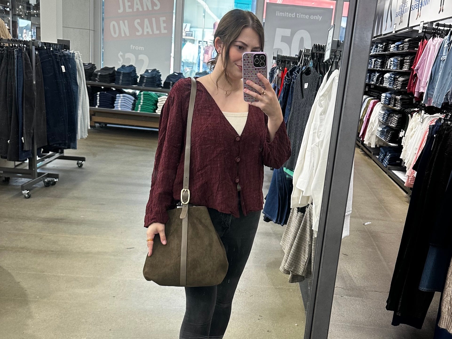 Reporter Amanda Krause tests a suede bag at Old Navy.