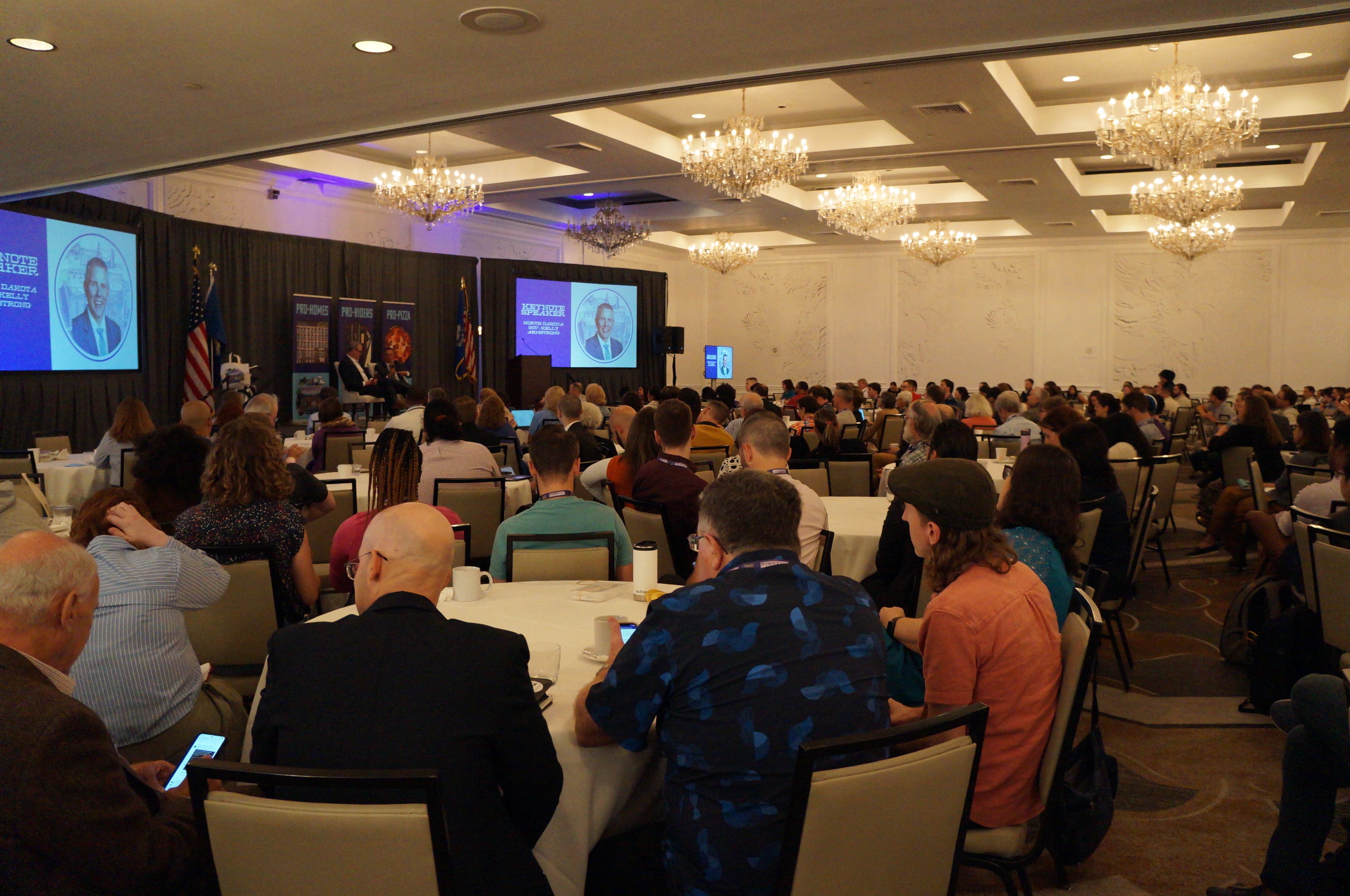 YIMBYtown conference attendees listen to North Dakota Gov. Kelly Armstrong talk.