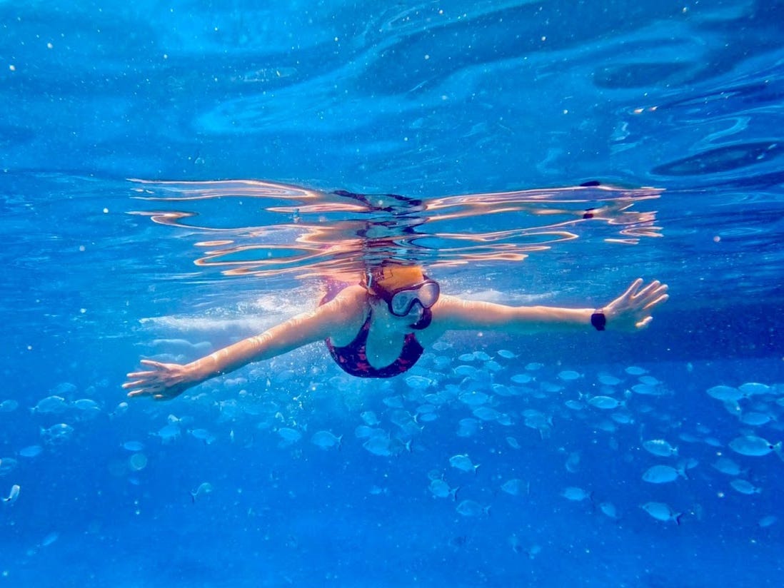 Fiona Govan underwater with fish near Greek islands.