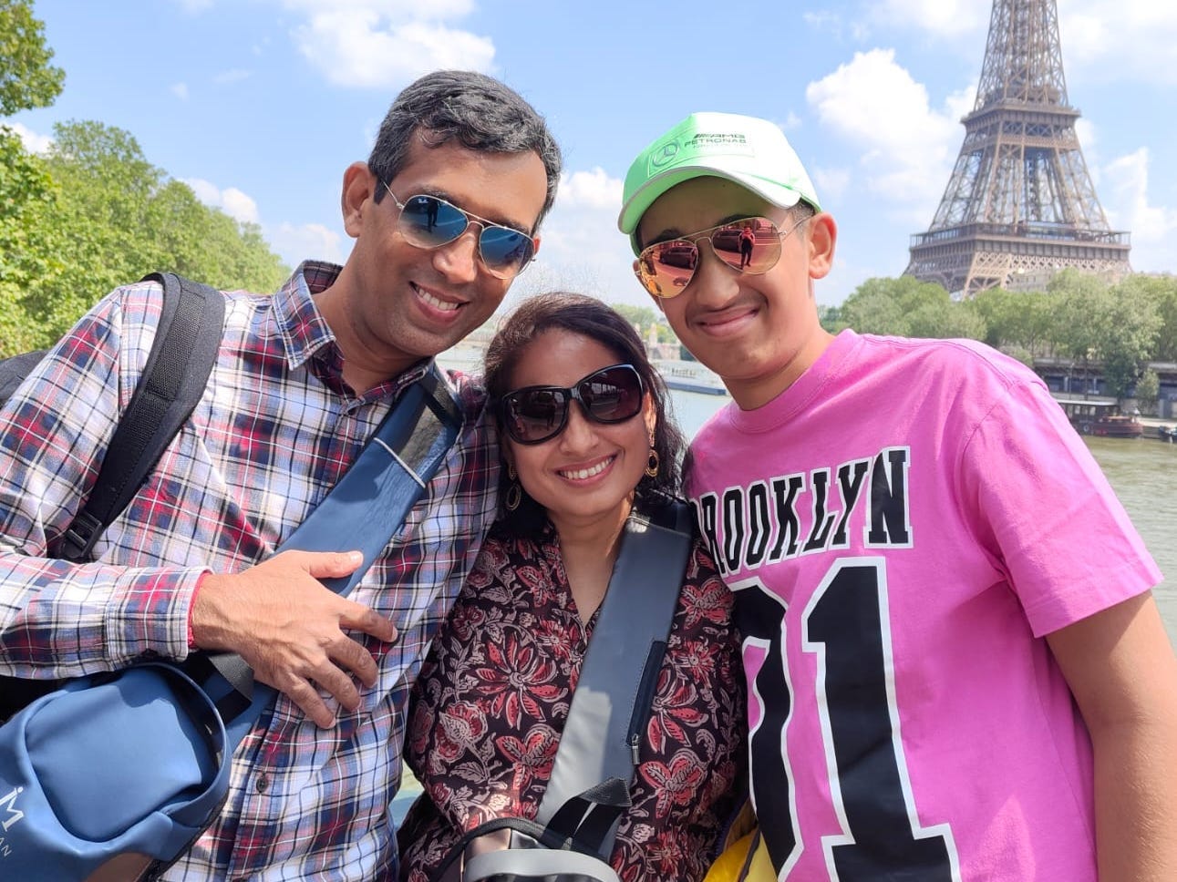 Sripriya Balasubramaniam with her husband and son in front of the Eiffel Tower.