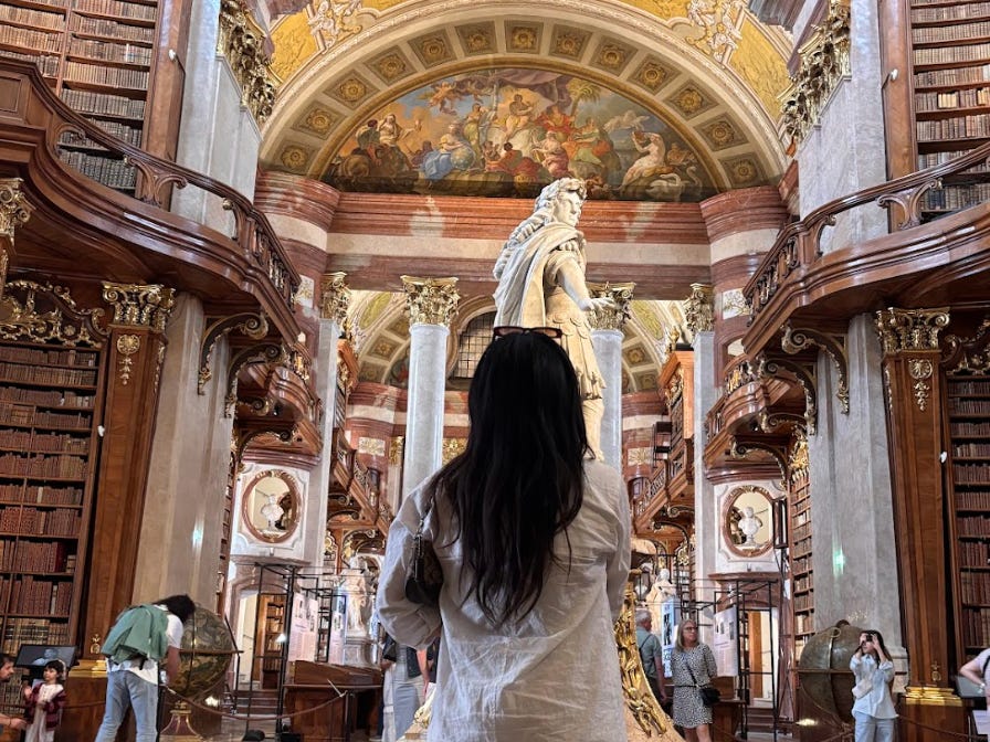 The writer staring at a statue in a European museum.