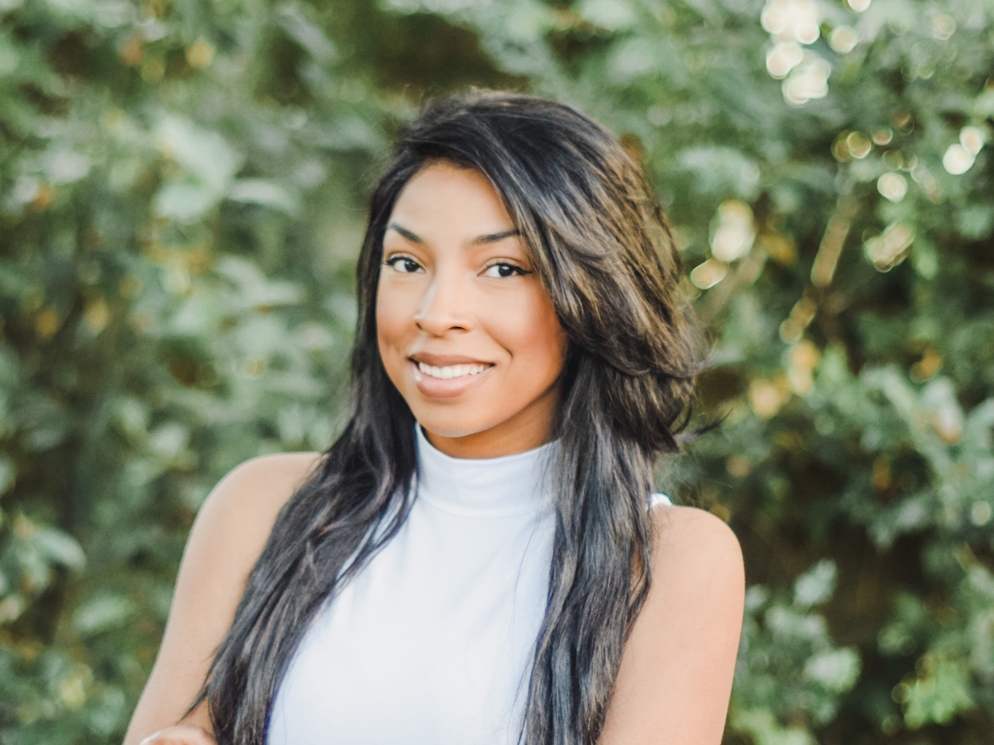headshot of a woman outside in front of a tree