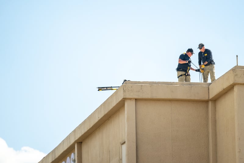 Members of the FBI investigate a building allegedly used by a shooter in the attack near a U.S. Immigration and Customs (ICE) detention facility