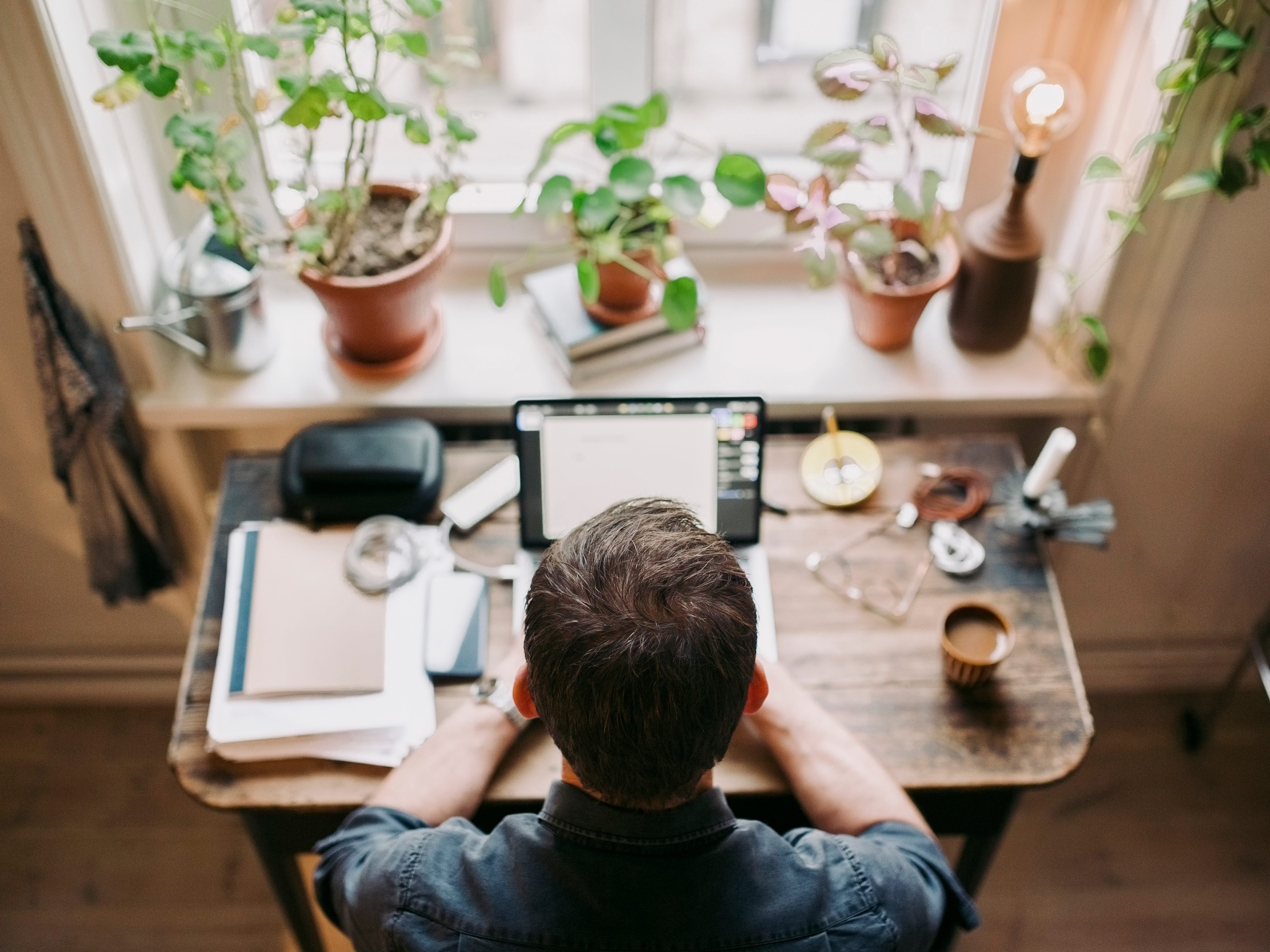 Overhead view of man working from home at a desk.
