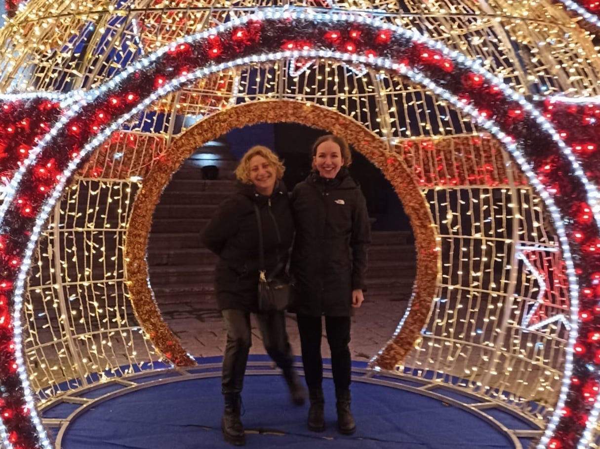 The author poses with her aunt at an outdoor light instillation.