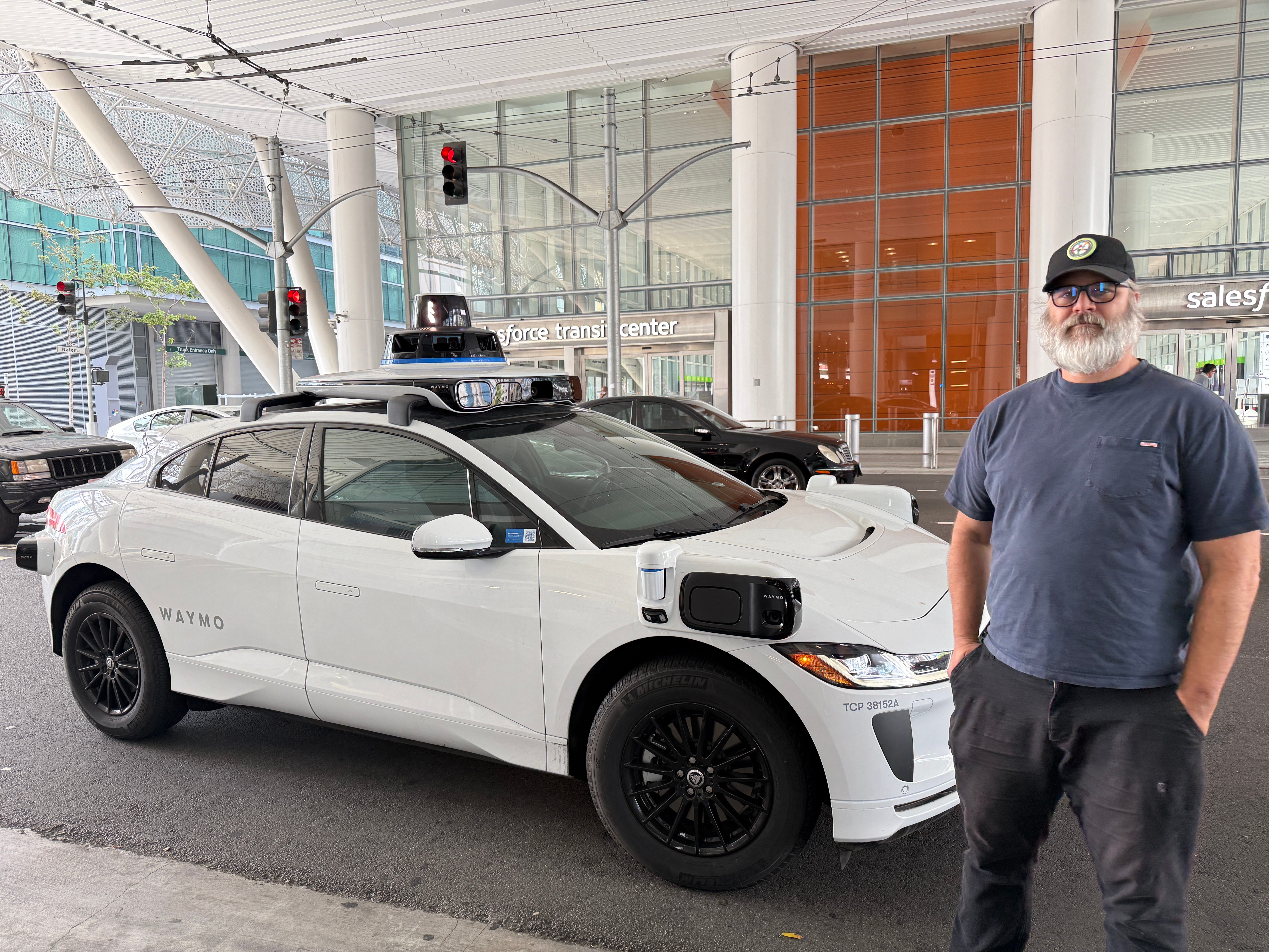Man standing in front of a Waymo