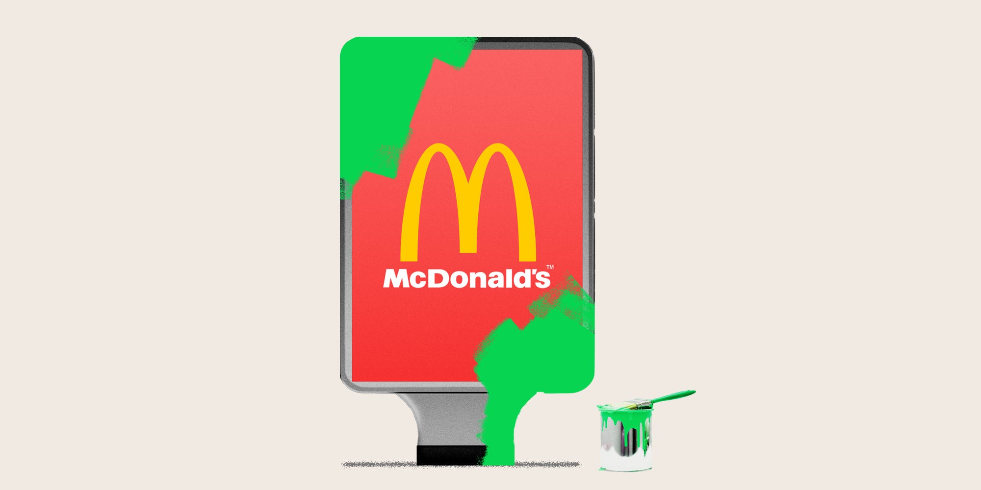 A sign displaying a McDonald's logo with green paint covering it
