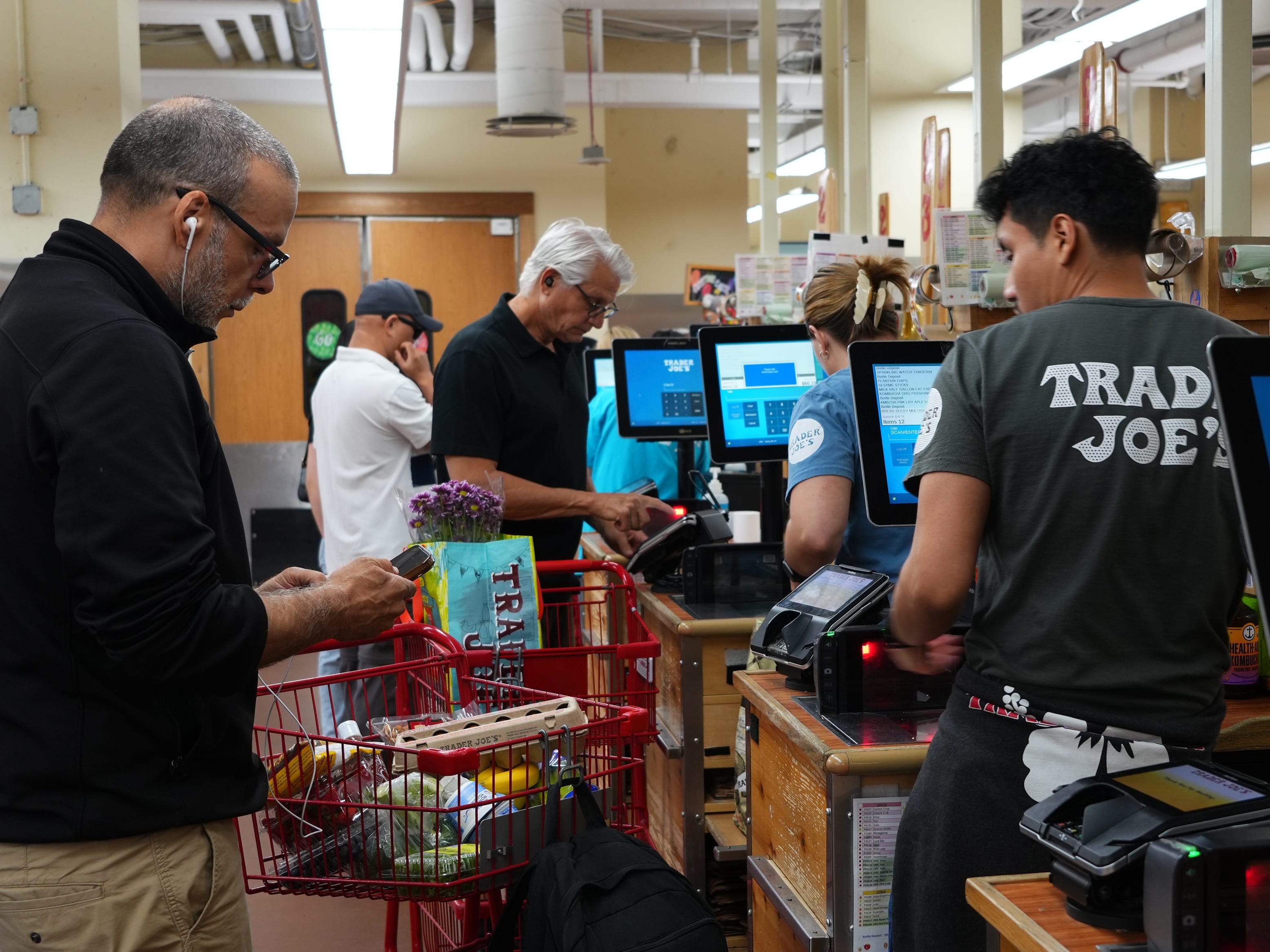 Customers and workers at a grocery store