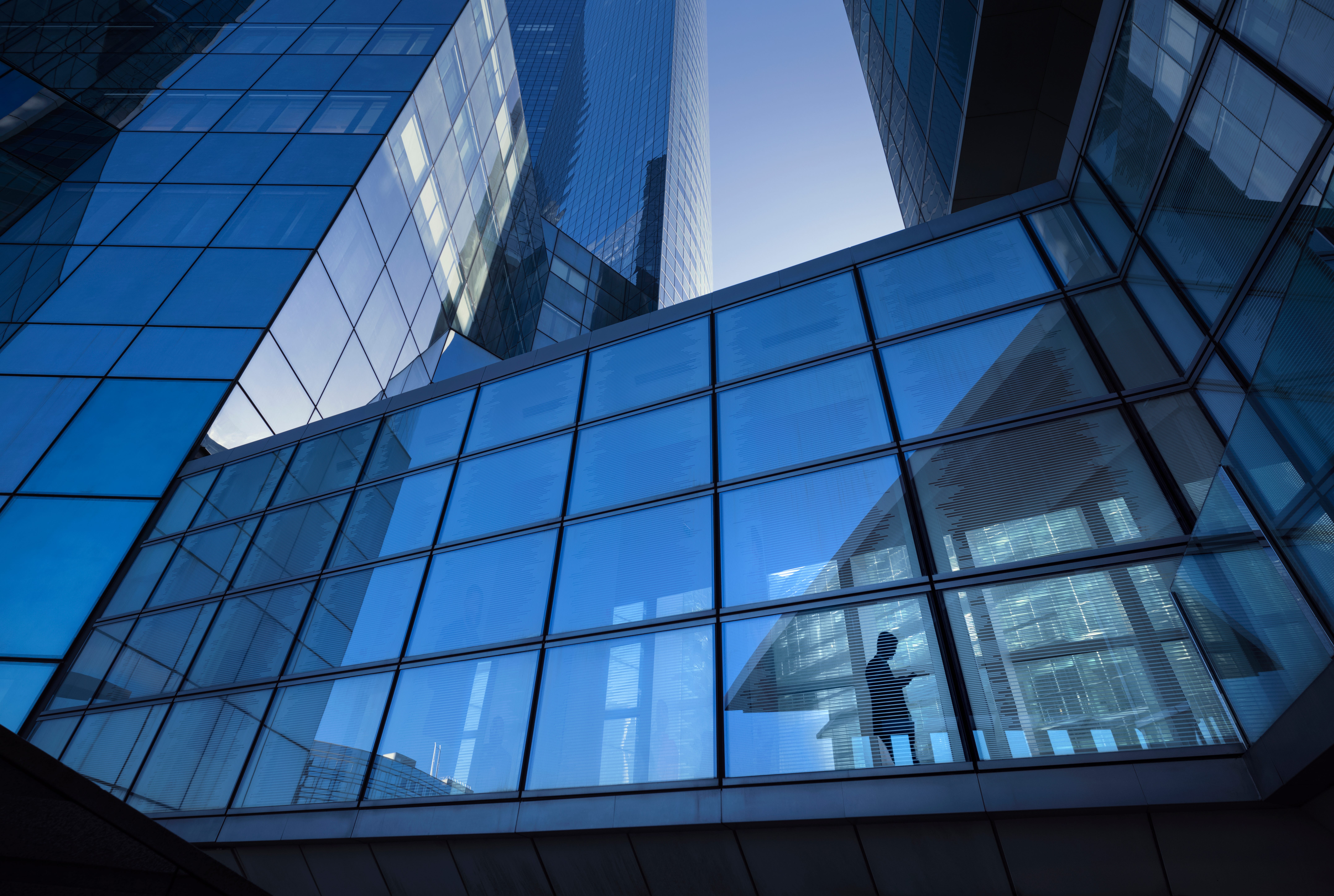A person is silhouetted in an office building.