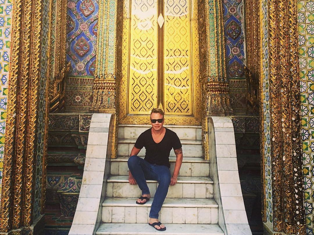 Andre Neveling sitting on steps in Bangkok.