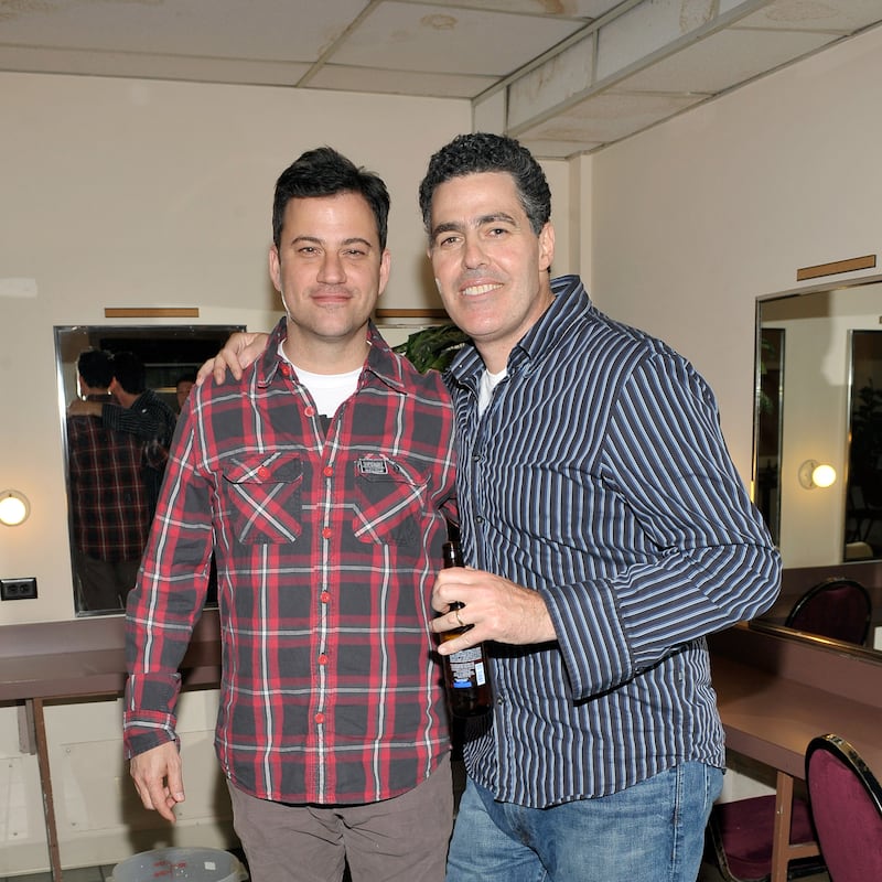 Comedians Jimmy Kimmel helps Adam Carolla celebrate the release of his new paperback book 