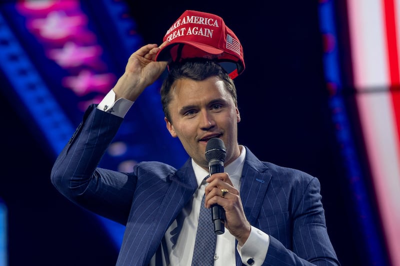 Charlie Kirk puts on a MAGA hat during the AmericaFest 2024 conference sponsored by conservative group Turning Point in Phoenix, Arizona, U.S. December 19, 2024.