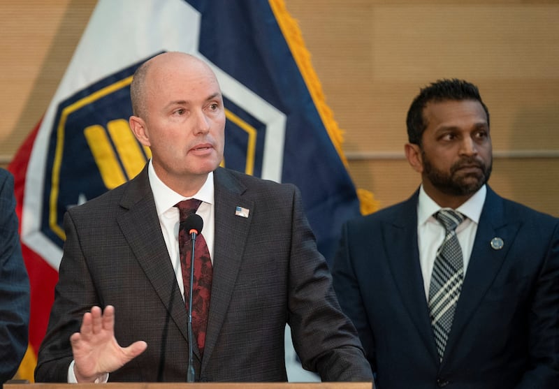 Utah Governor Spencer Cox, with FBI Director Kash Patel, gestures as he speaks during a press conference announcing details on the suspect in the shooting of Charlie Kirk.