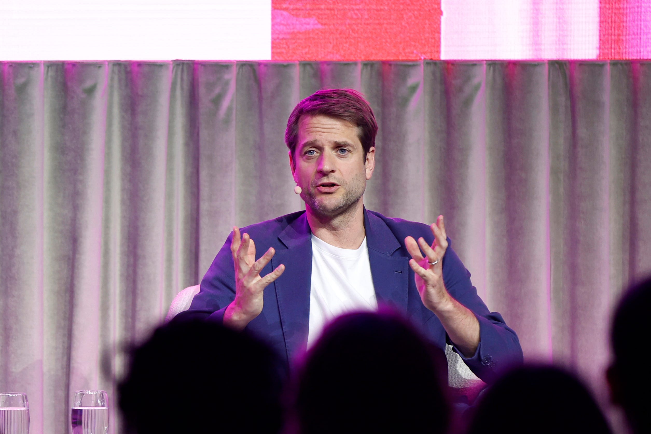 Klarna CEO Sebastian Siemiatkowski on a stage wearing a blue blazer jacket