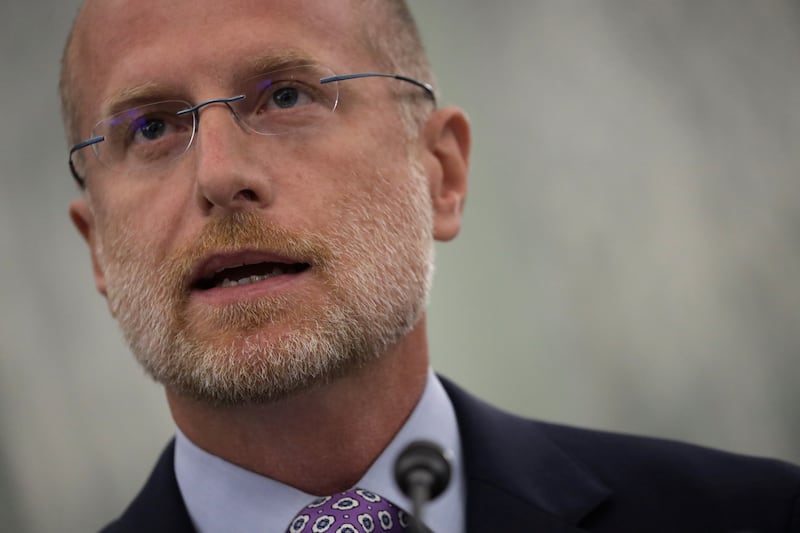 A close cropped photograph of the face of Commissioner of Federal Communications Commission Brendan Carr.