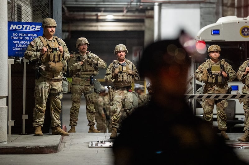 National Guard soldiers stand on duty in front of the federal Metropolitan Detention Center on July 26, 2025 in Los Angeles after President Trump first ordered the deployment of troops to the city.