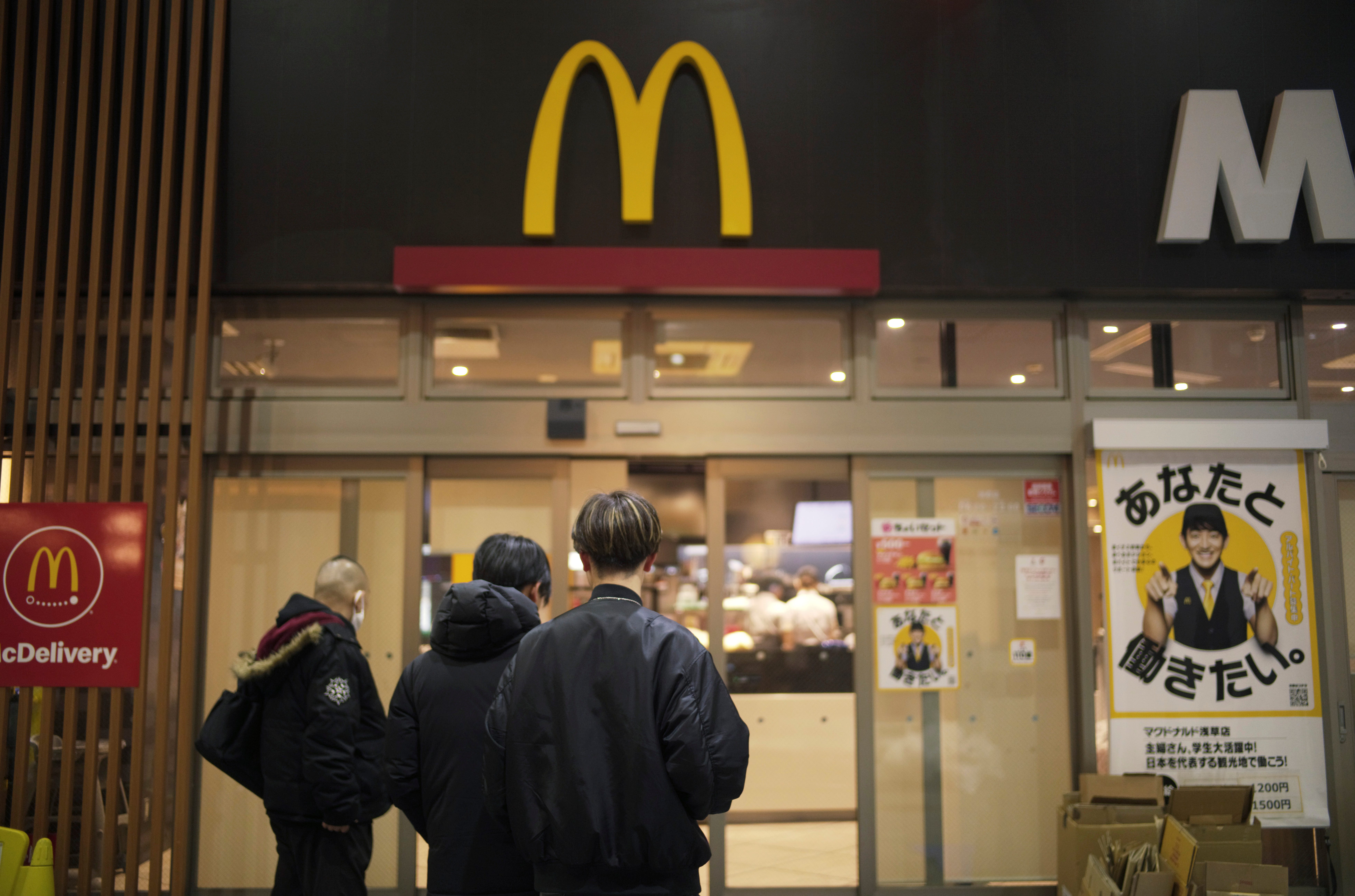 People stand outside a McDonald's store in Tokyo, March 15, 2024.