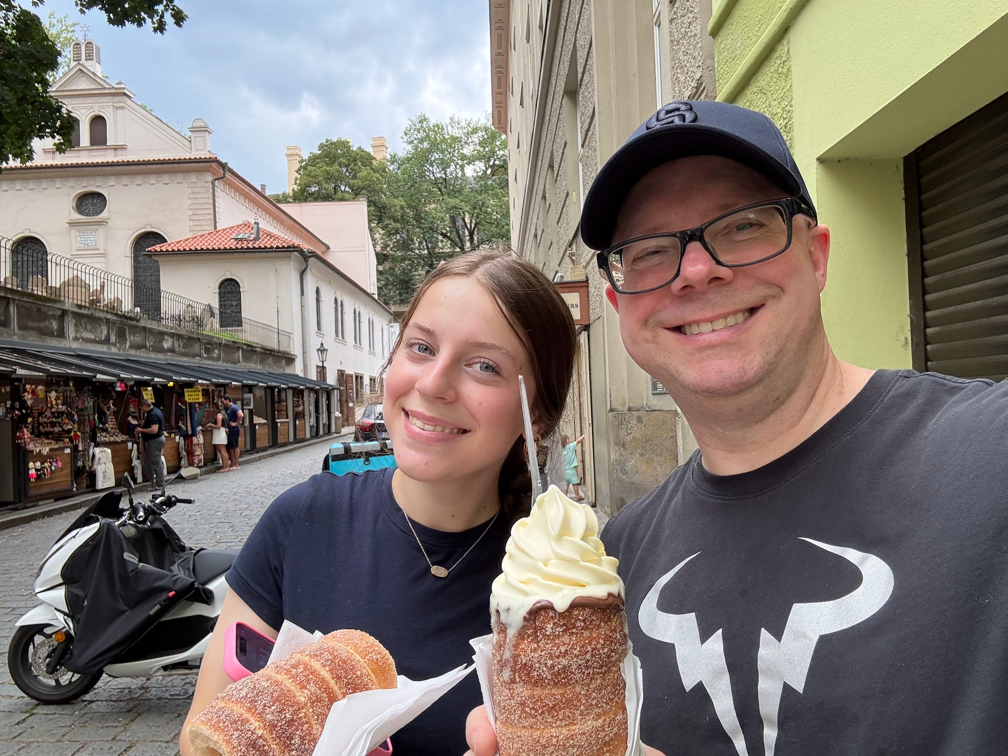 gina richs husband and daughter holding up ice cream in prague