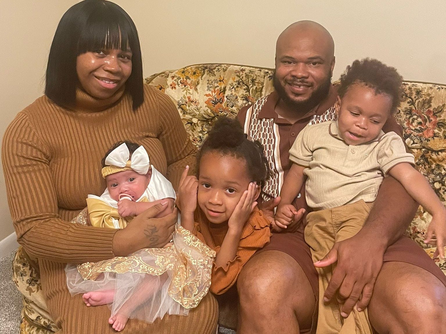 A family of five sitting on a couch